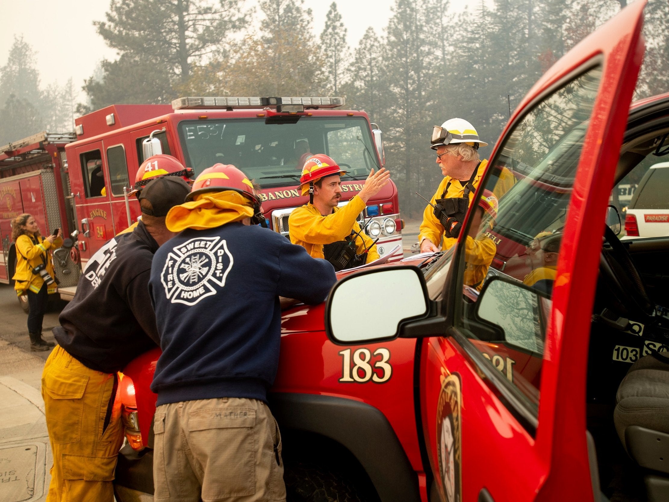 Firefighters plan their operations while battling the Camp Fire in Paradise, California