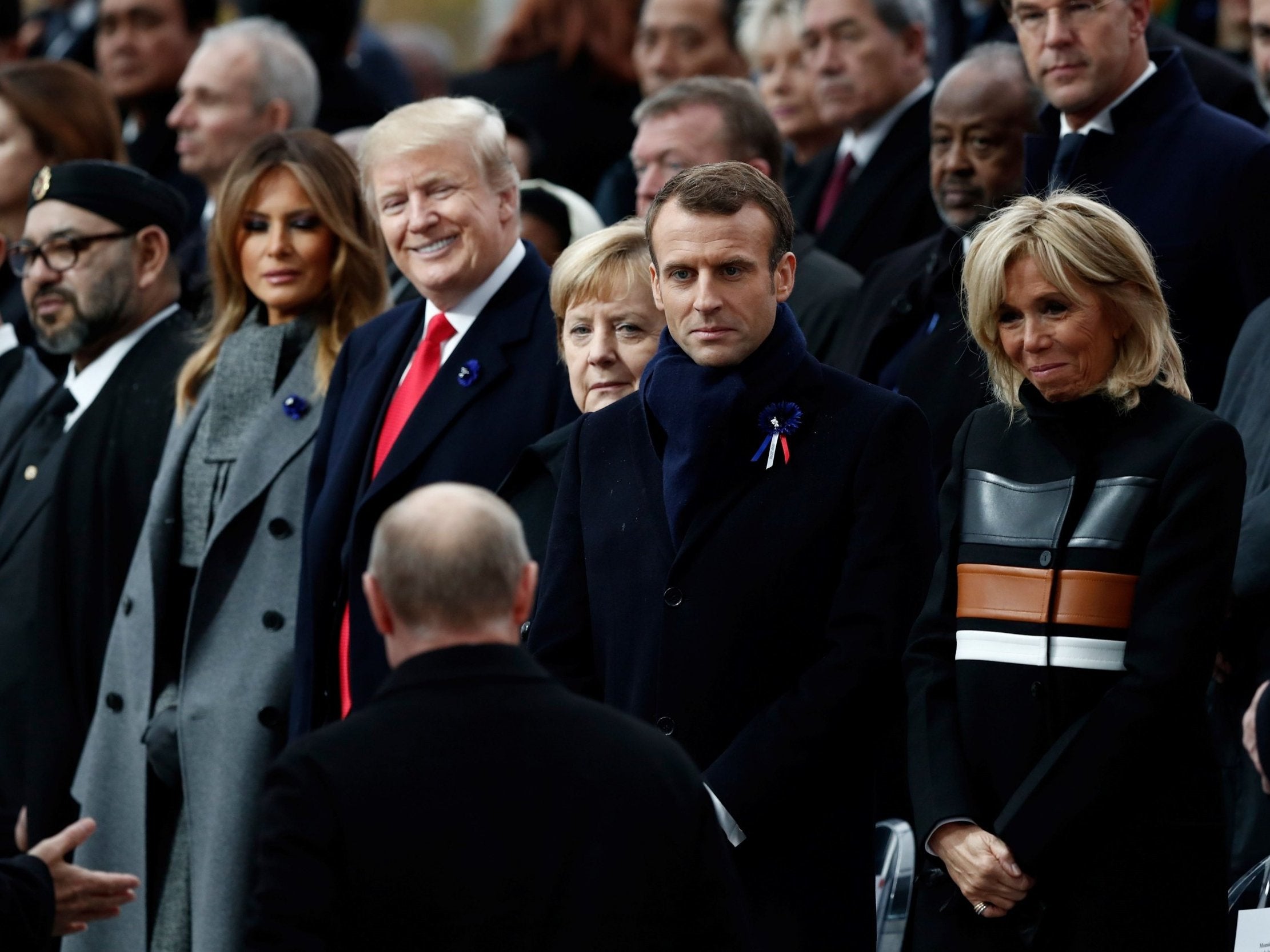 Donald Trump beams at the approach of Vladimir Putin in Paris (AFP/Getty)