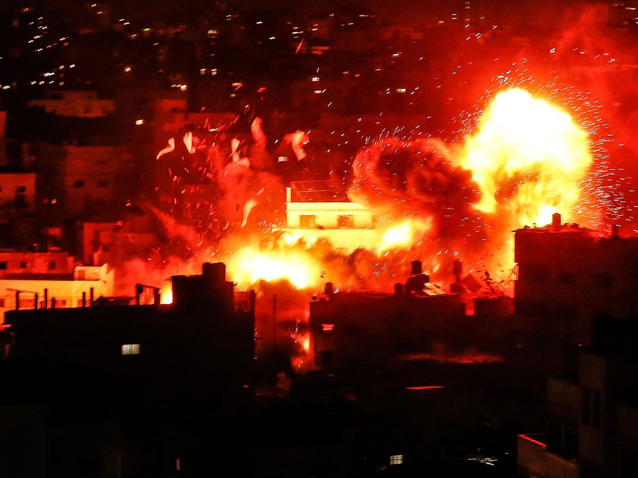 A ball of fire above the building housing the Hamas-run television station al-Aqsa TV in the Gaza Strip during an Israeli air strike on 12 November