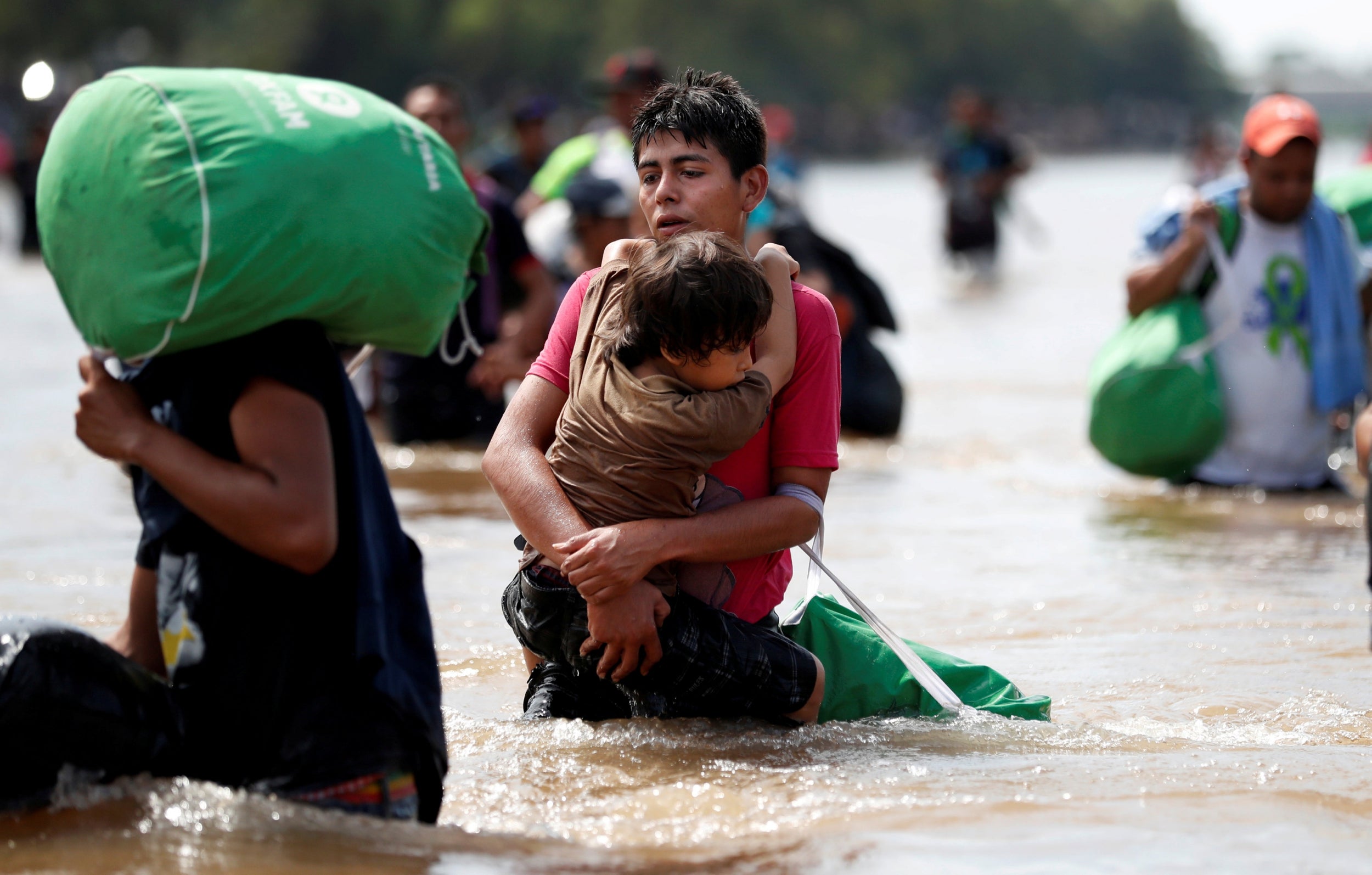 Migrants struggle to cross the river from Guatemala to Mexico