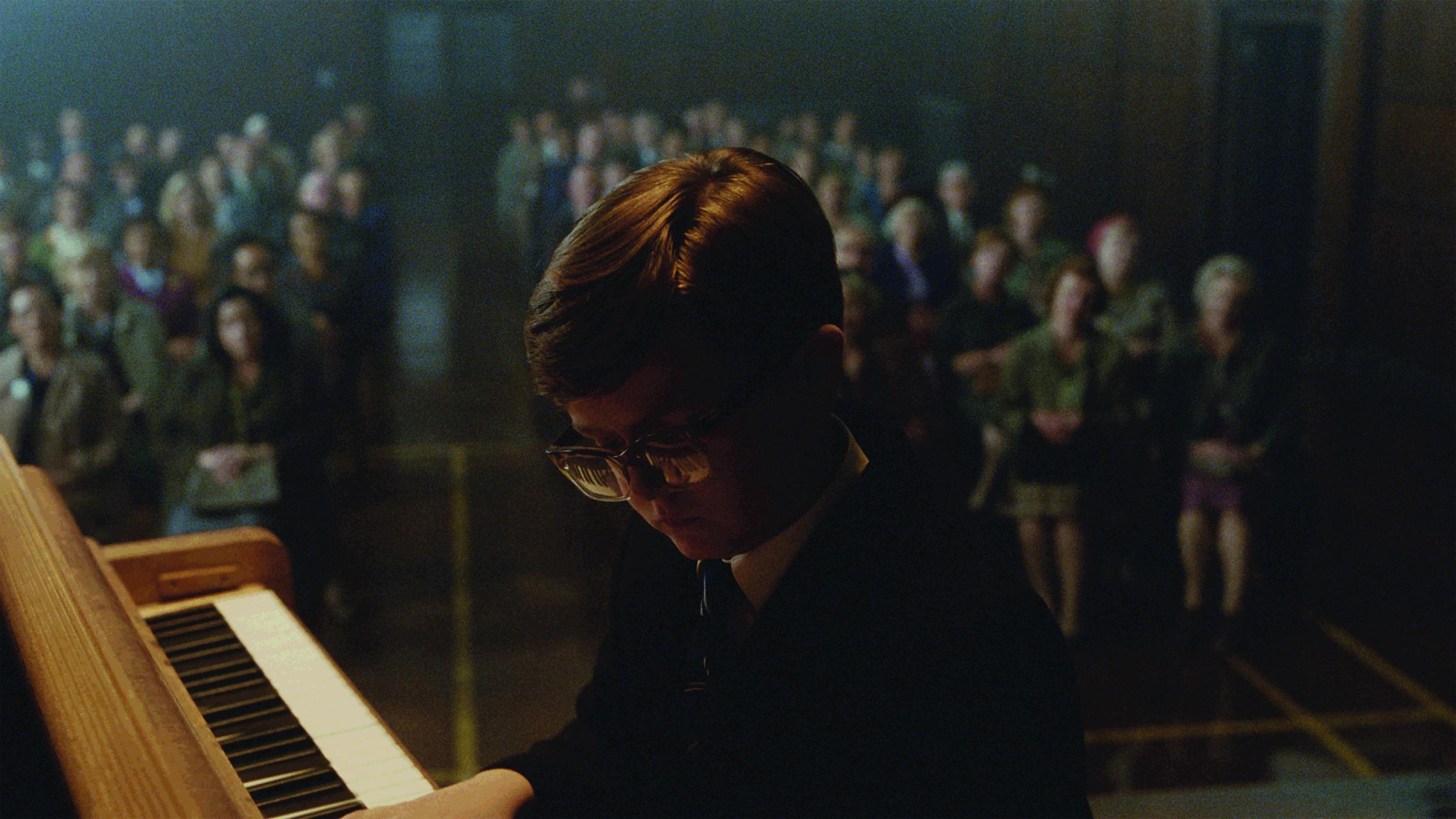 An actor plays the young Elton John at a school recital (John Lewis)