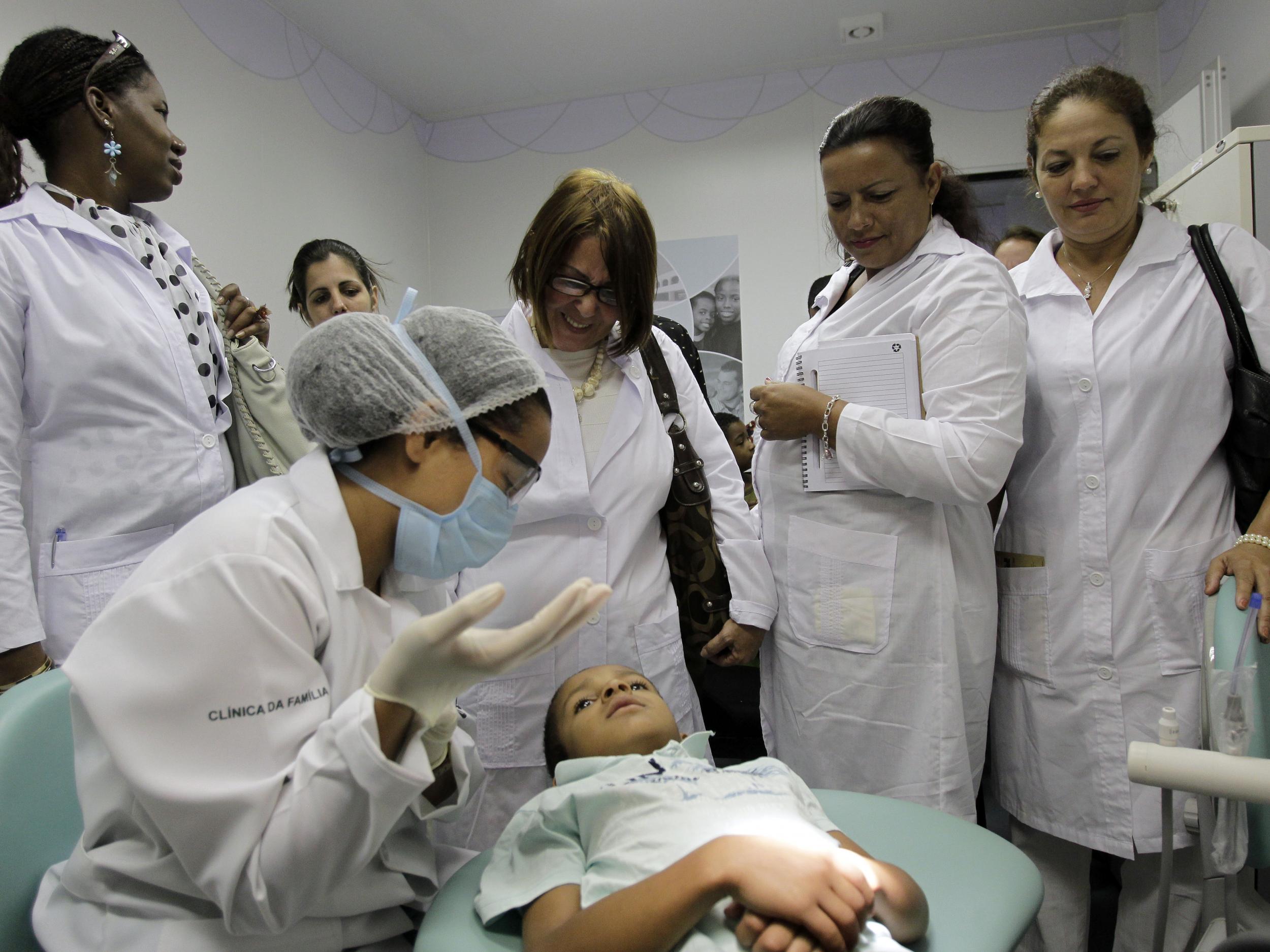 Cuban doctors observe a procedure at a health clinic in Brasilia, Brazil