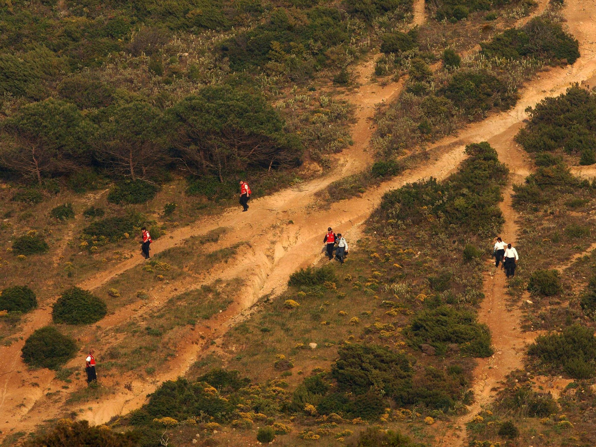 Red Cross volunteers search Luz in the Algave, Portugal, after Madeleine McCann went missing in 2007