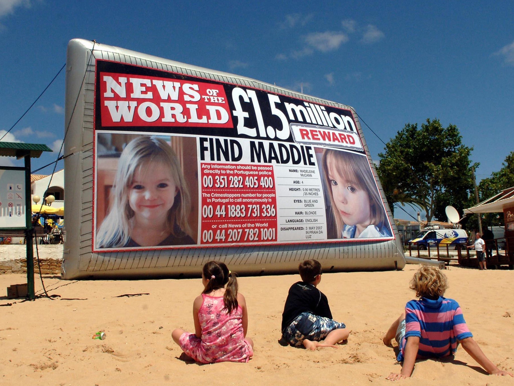 An inflatable News of the World poster of missing Madeleine McCann on the beach in Praia Da Luz, Portugal