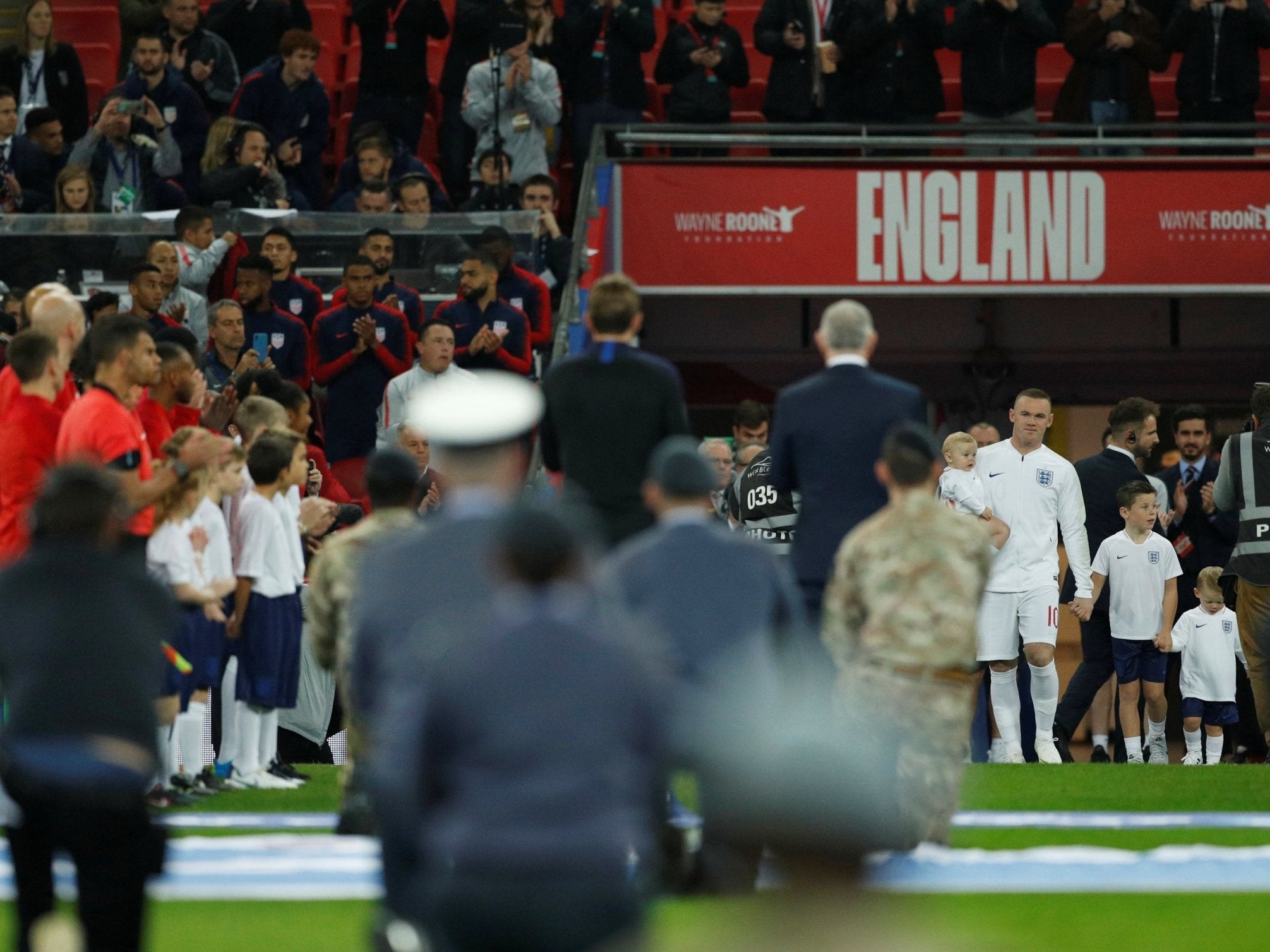 Wayne Rooney is welcomed on to the field at Wembley