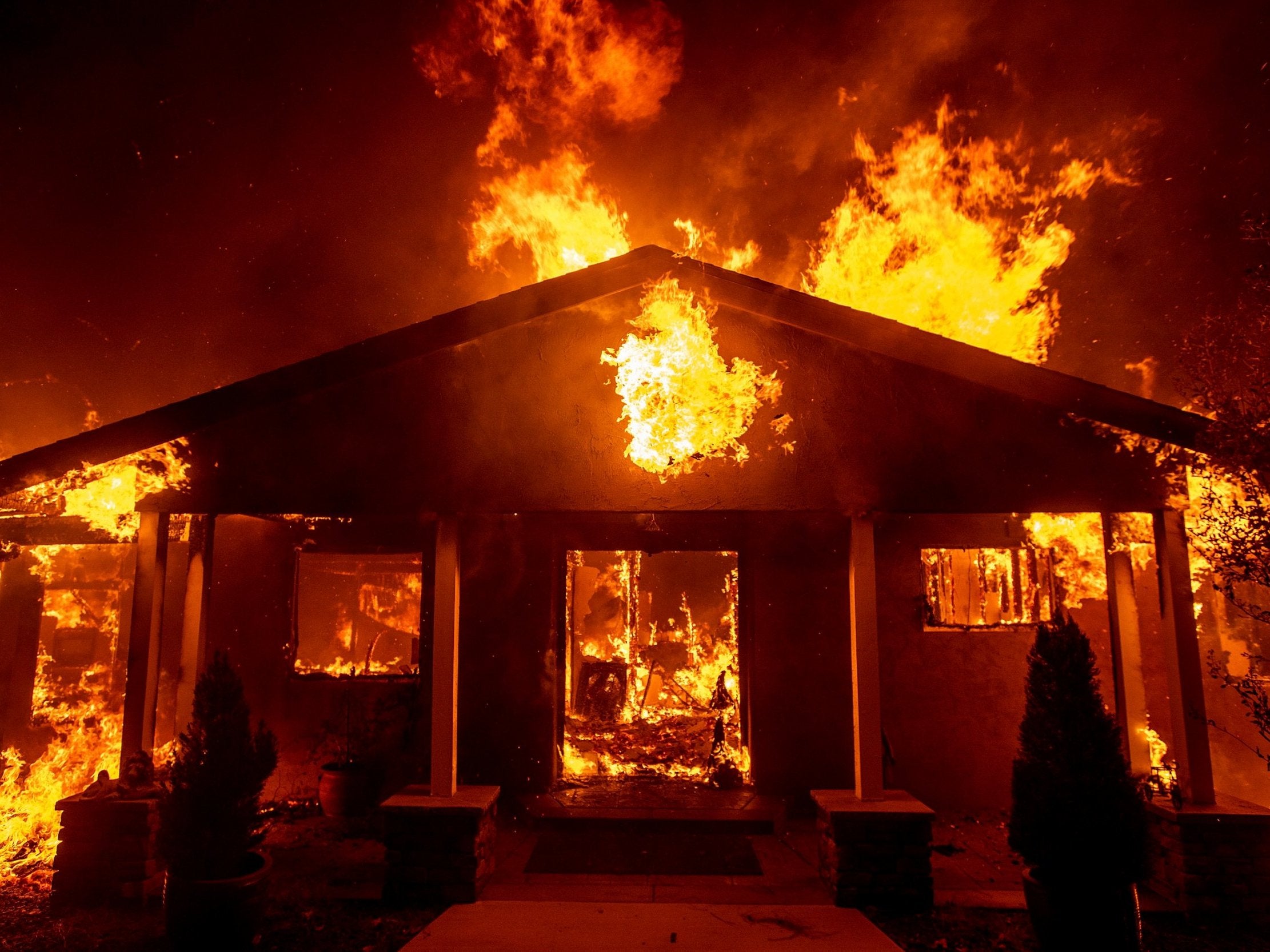 A home burns as the Camp Fire rages through Paradise, California