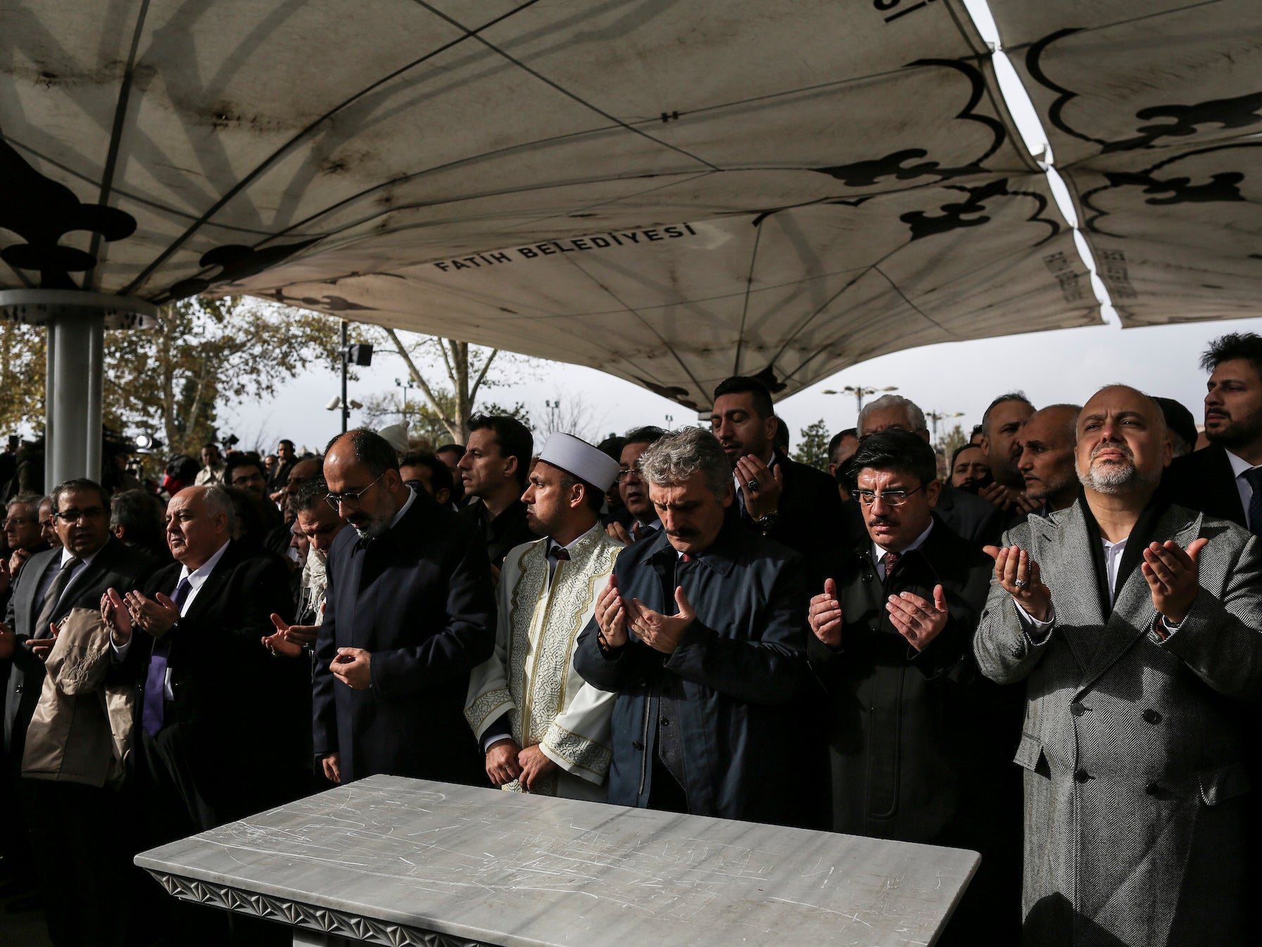 Mourners gather before an empty funeral slab to perform an absentia burial ceremony for Jamal Khashoggi (Tara Todras-Whitehill)