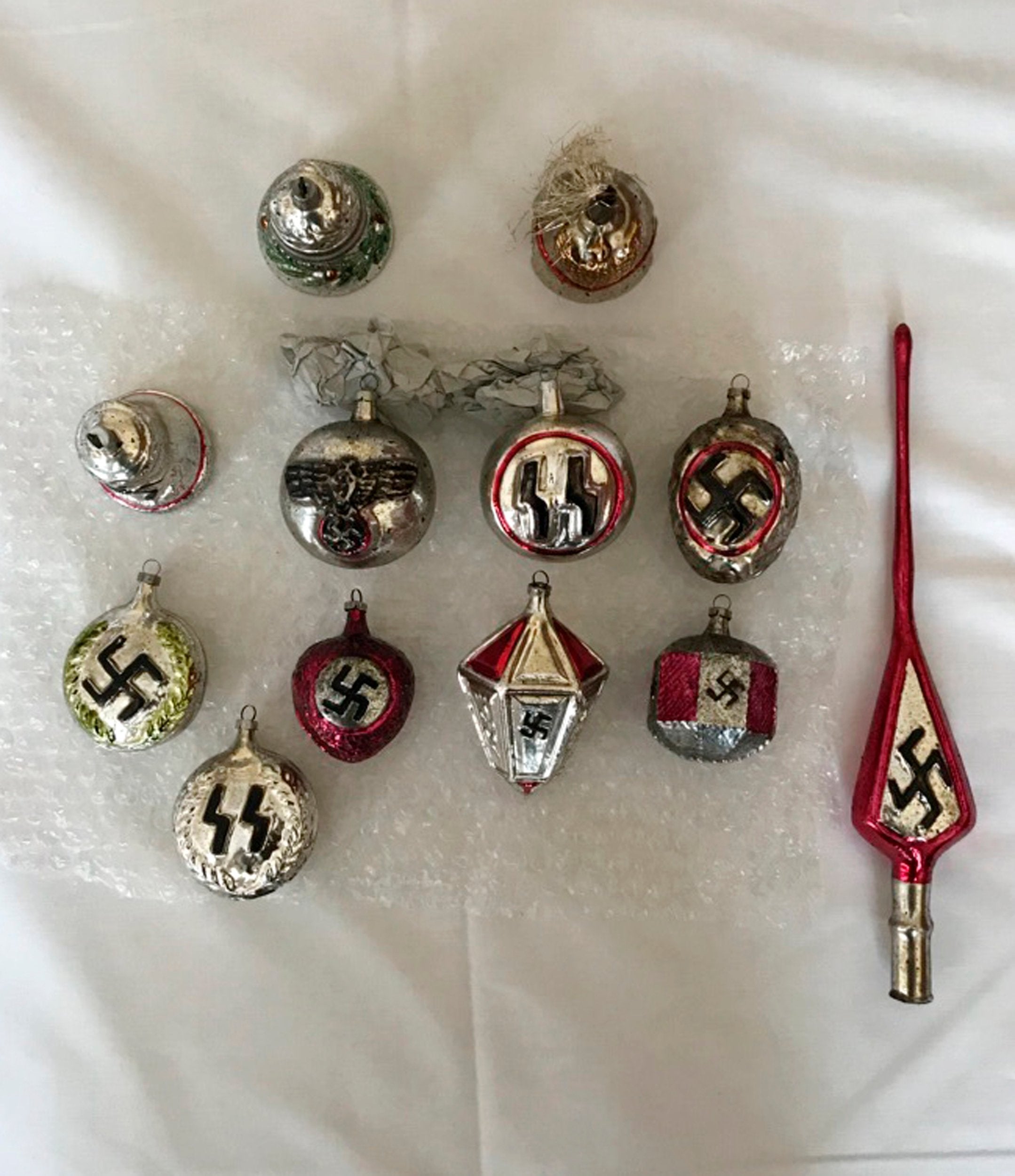 In this undated photo Christmas baubles bearing Nazi insignia are displayed