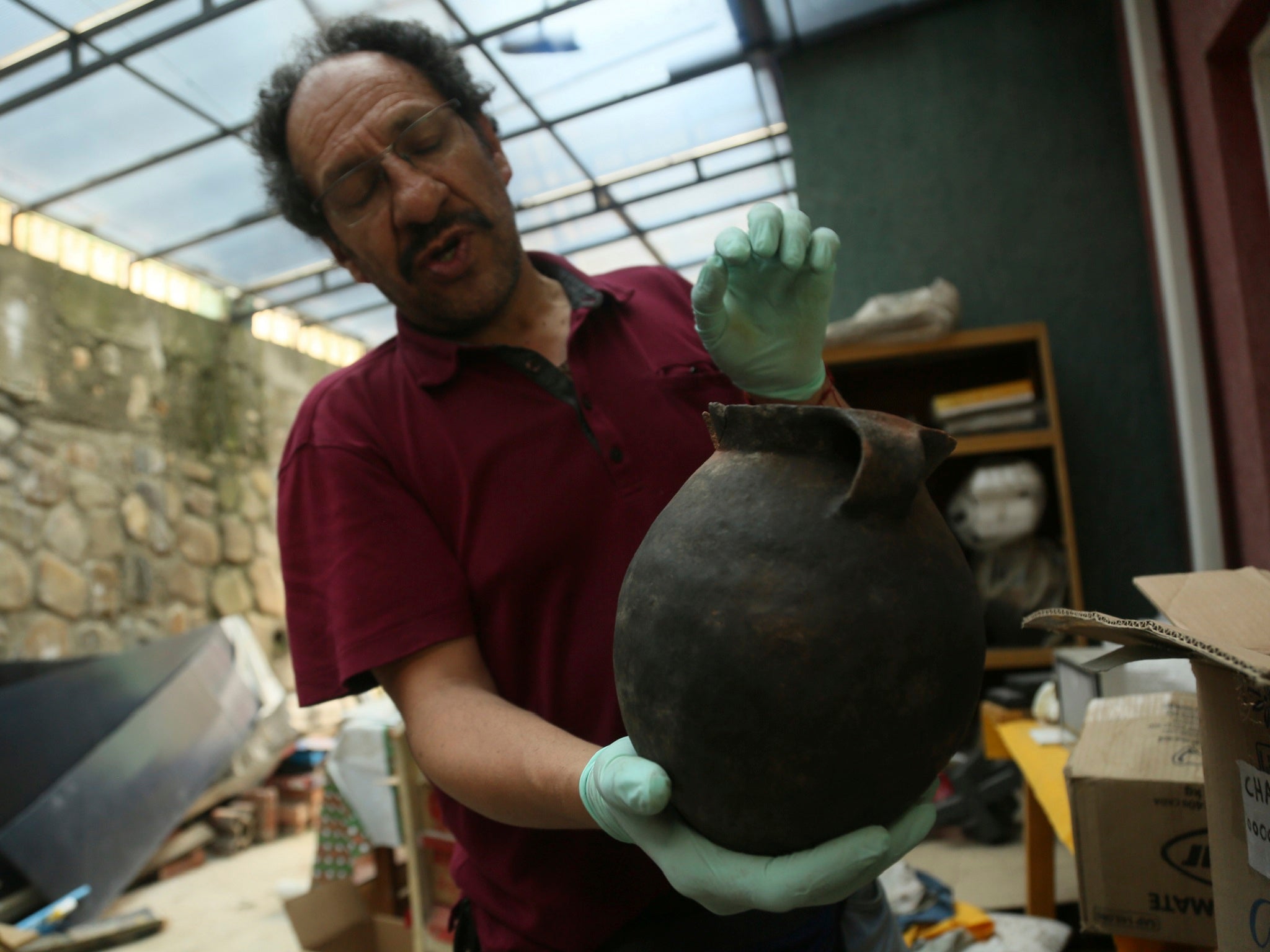 Jedu Sadarnaga shows pottery on November 15, 2018 from one of the tombs found at a Bolivian quarry near the capital of La Paz. The tombs contained remains belonging to more than 100 individuals and were buried with more than 30 vessels used by the Incas.