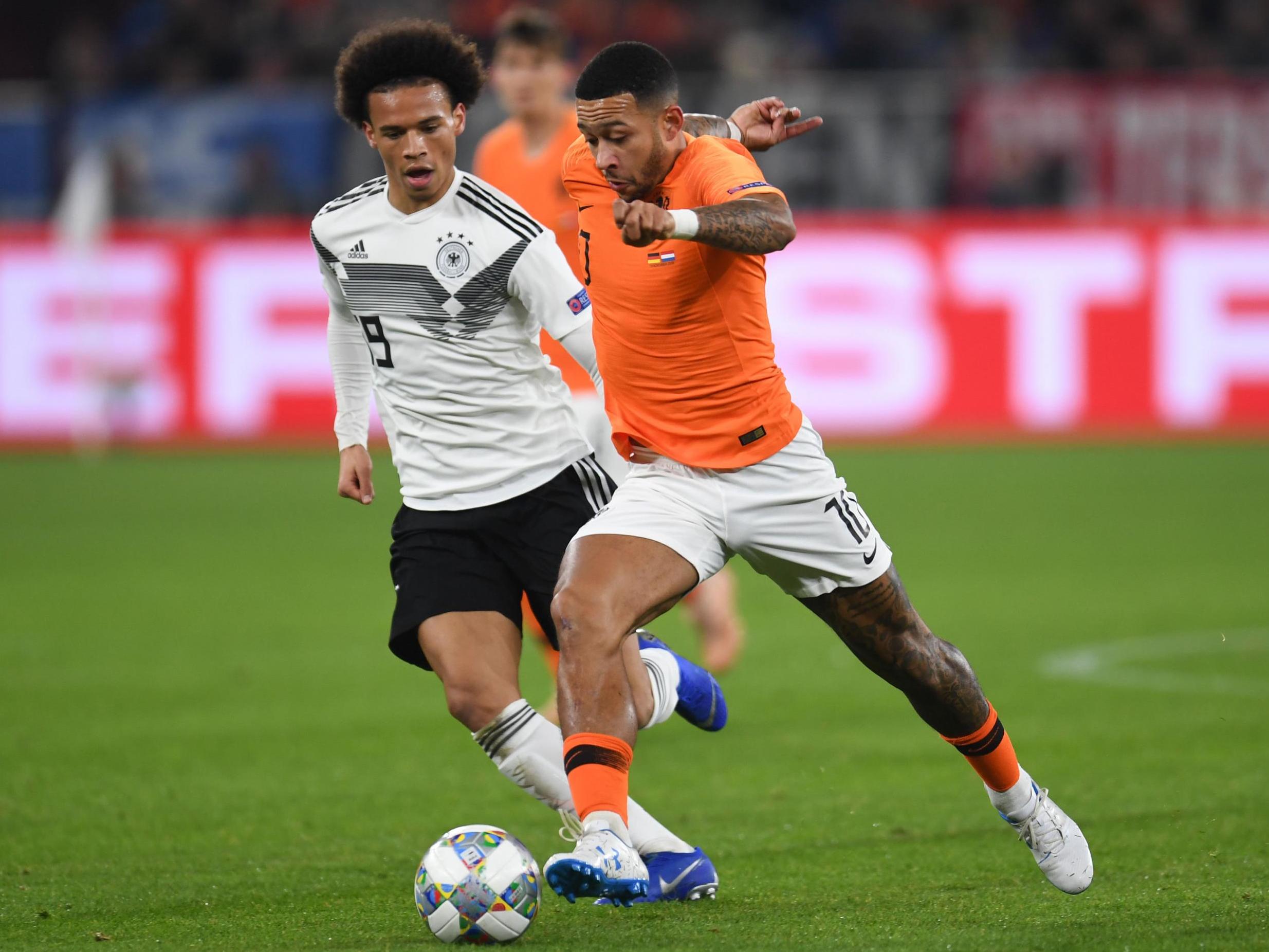 Memphis Depay attempts to get away from Leroy Sane