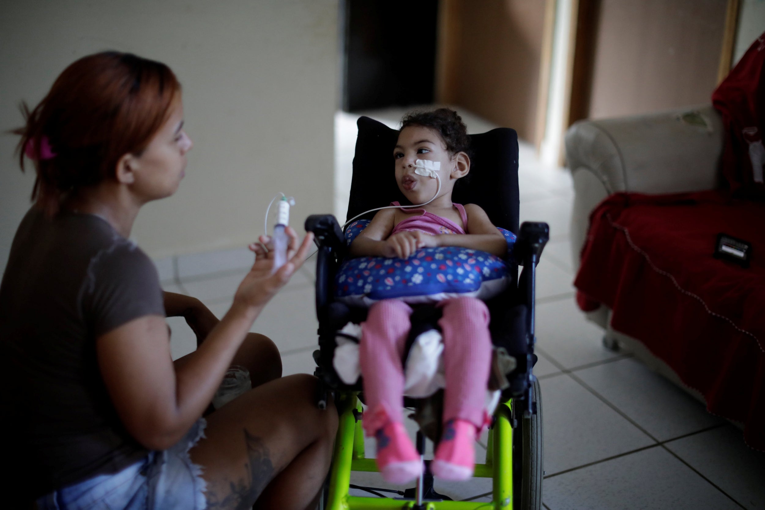 Rosana Vieira Alves feeds her two-year-old daughter Luana Vieira, who was born with microcephaly, at their house in Olinda, Brazil