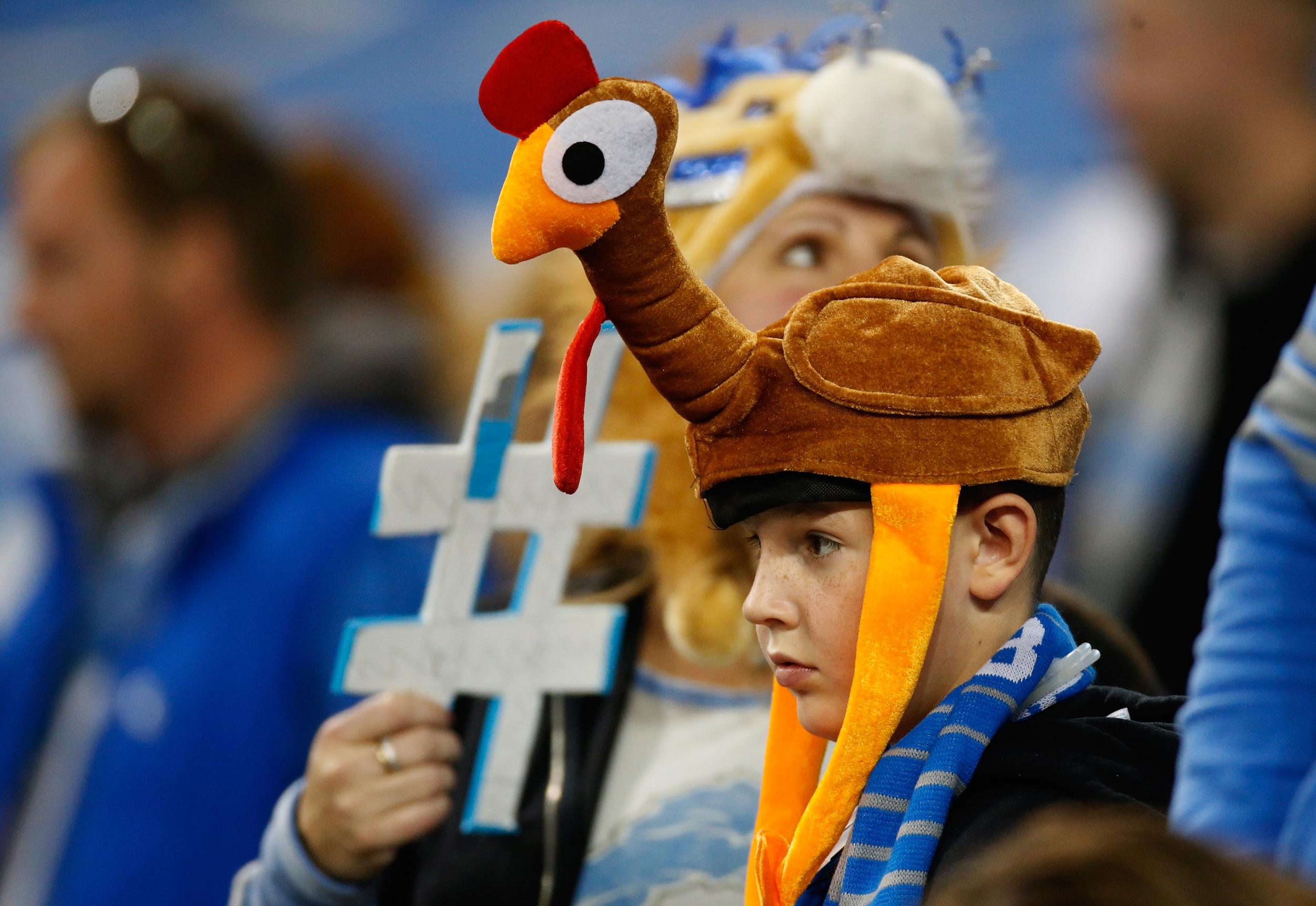 An NFL fan wears a turkey hat to a Thanksgiving game