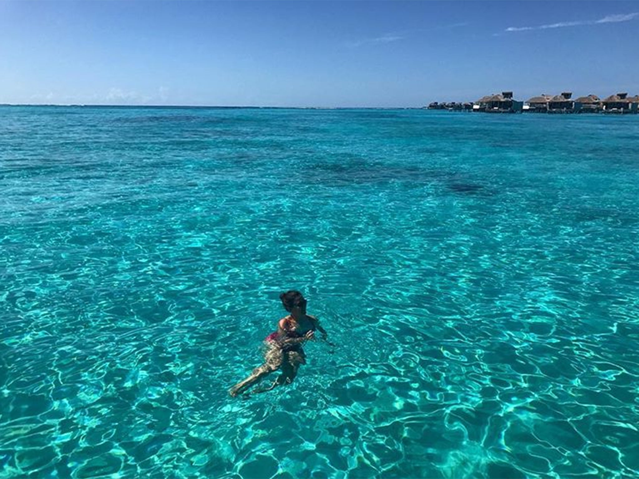 Swimming in glass-clear water in the Maldives