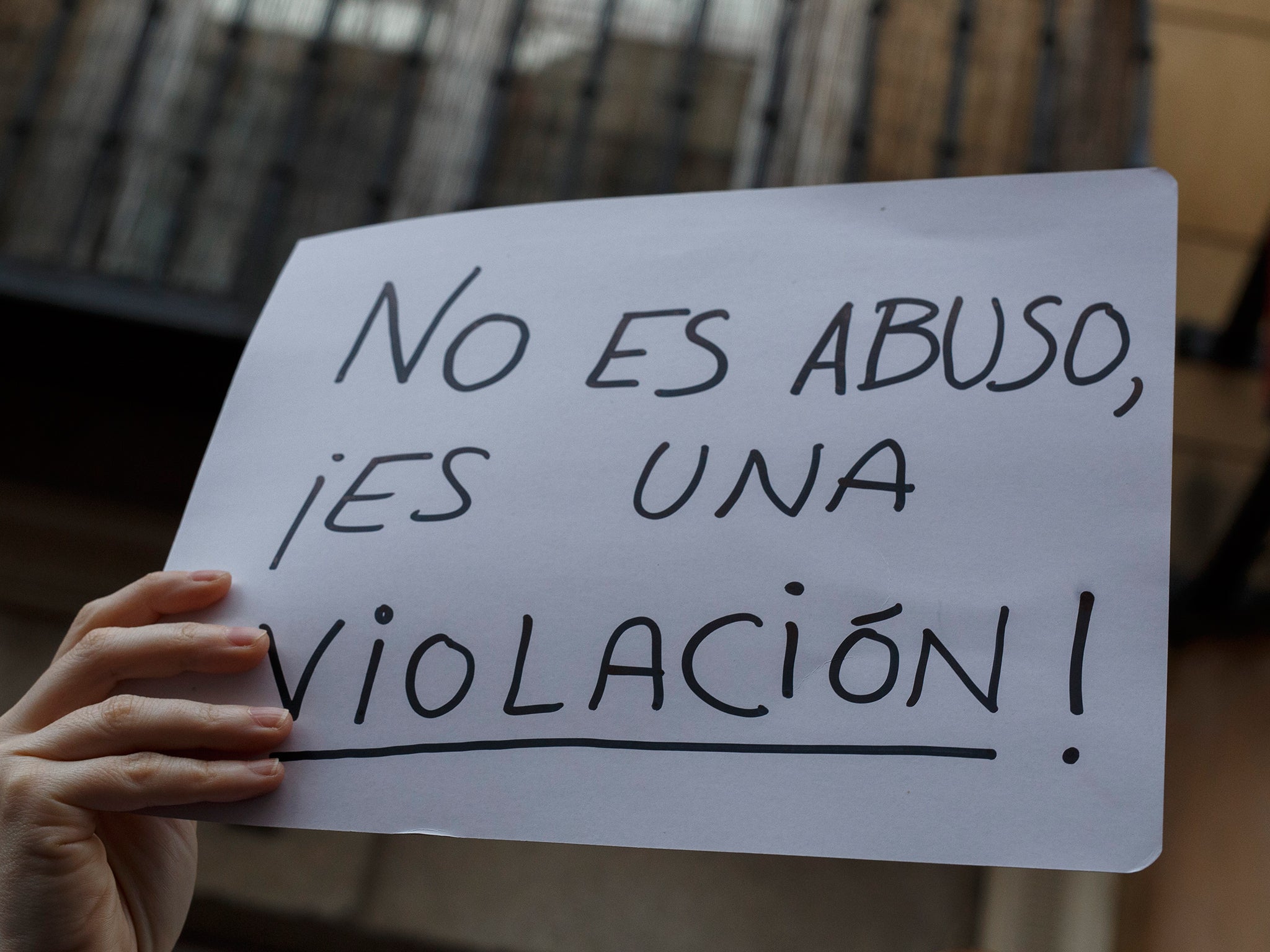 A protester holds a placard reading 'It is not abuse. It is rape!' during a demonstration against the verdict of the 'La Manada' (Wolf Pack) gang