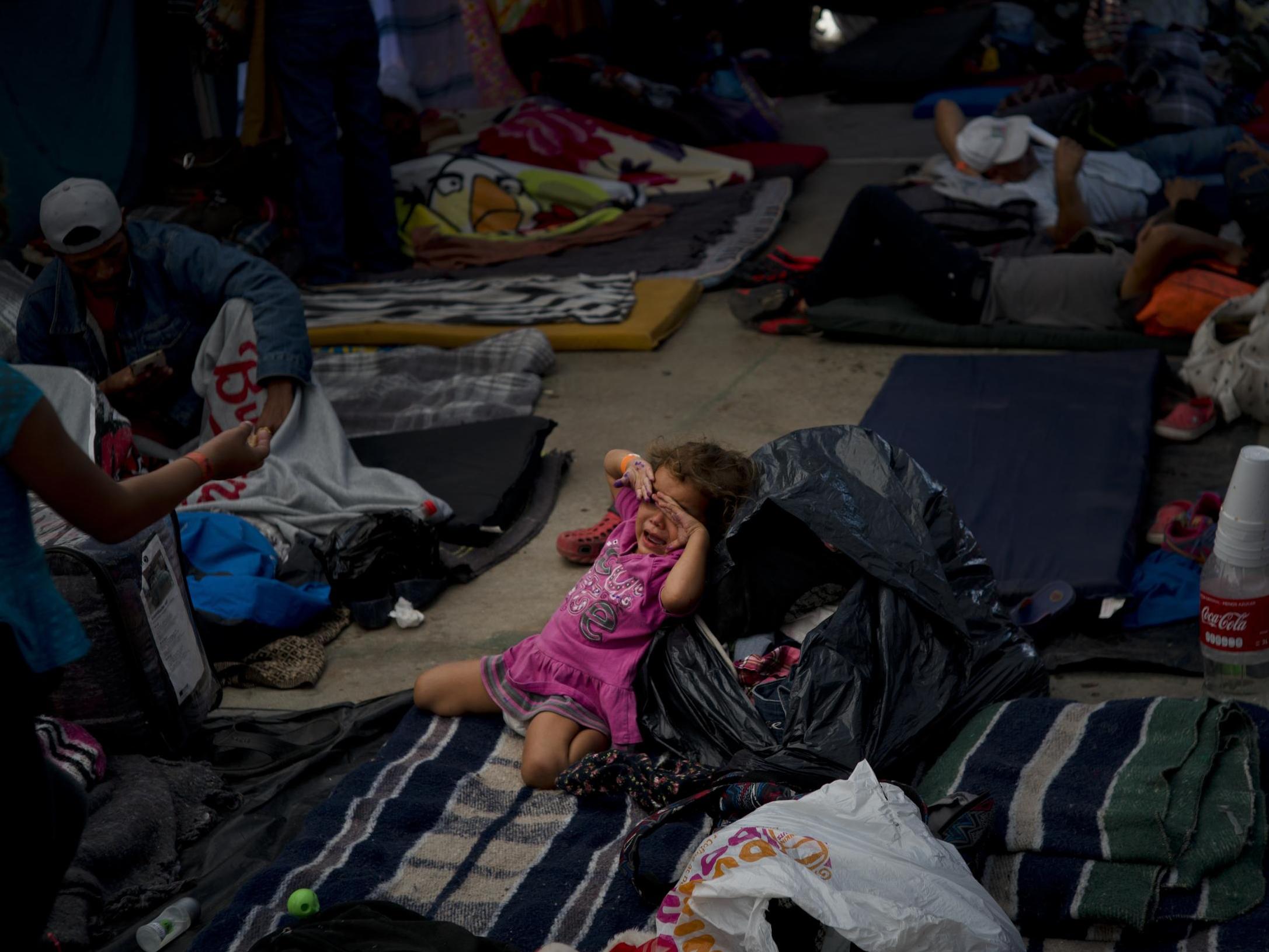 A young girl cries at a shelter in Tijuana, Mexico