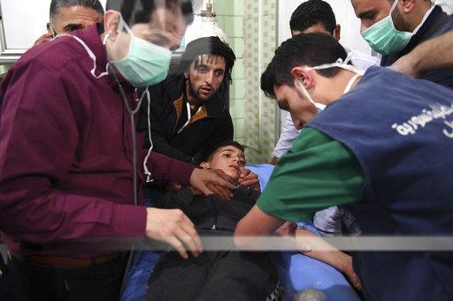 A boy is treated following the suspected chemical attack yesterday