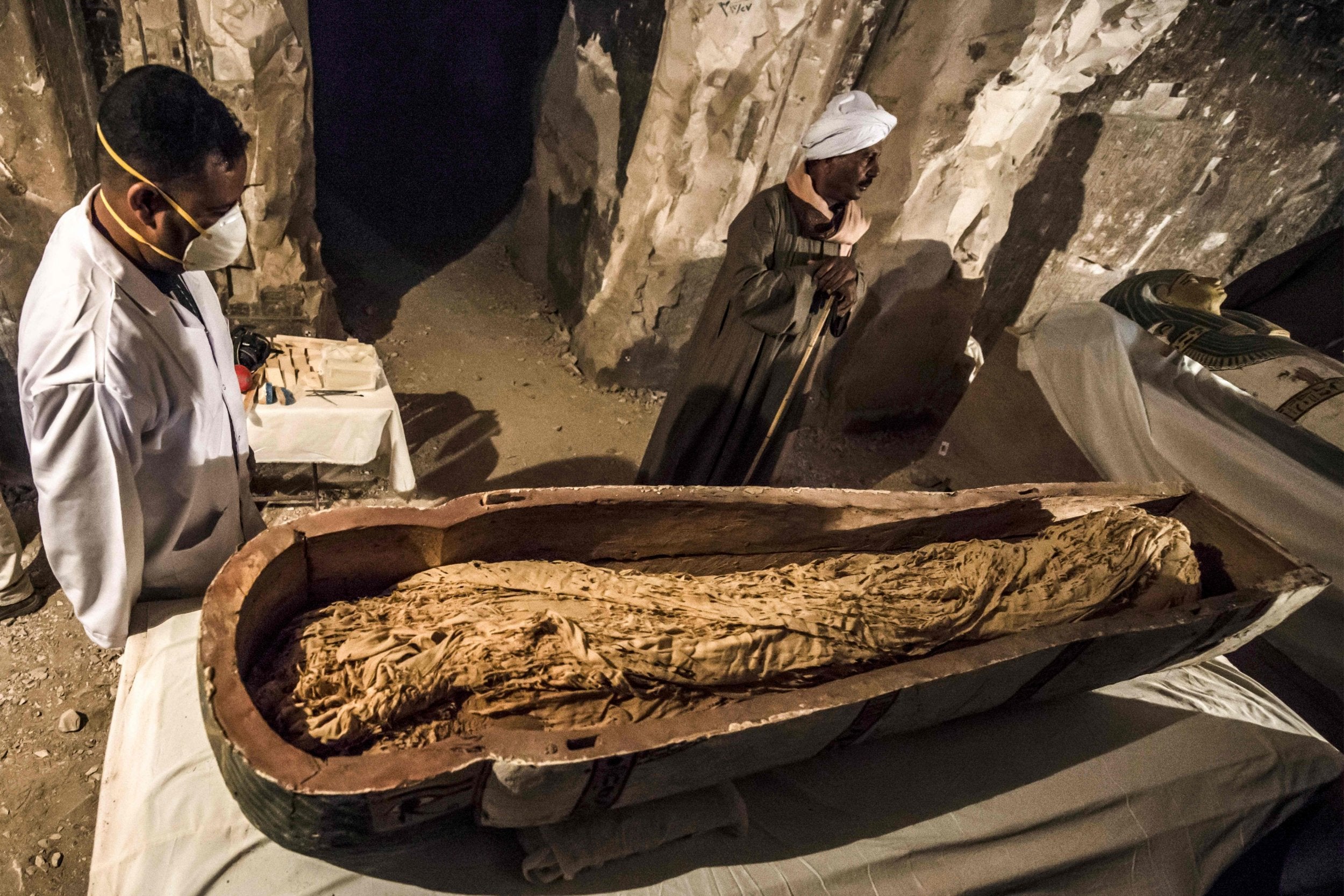 Egyptian workers and archaeologists examine the opened intact sarcophagus (AFP/Getty)