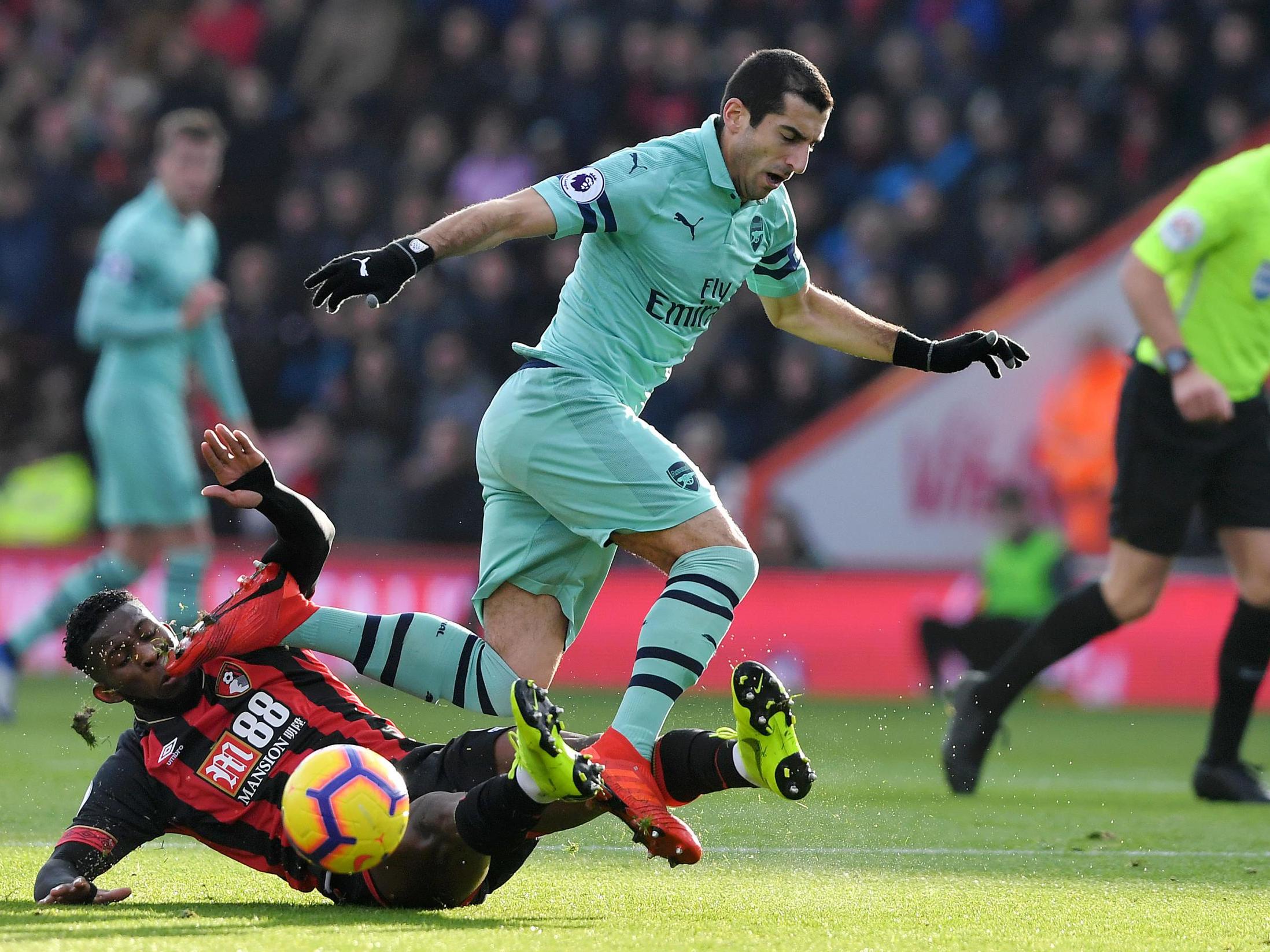 Jefferson Lerma dispossess Henrikh Mkhitaryan with a sliding challenge