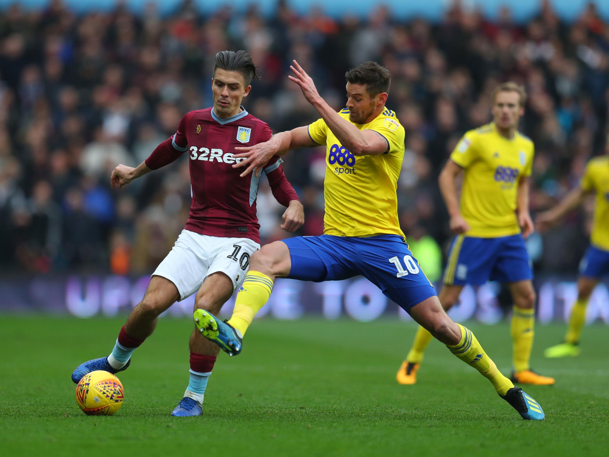 Birmingham City striker Lukas Jutkiewicz going in for a tackle on Jack Grealish