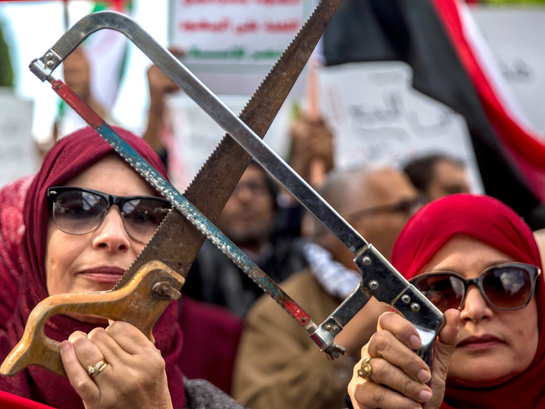 Tunisians demonstrate against the Saudi crown prince in Tunis on Tuesday, holding saws in reference to Khashoggi’s murder