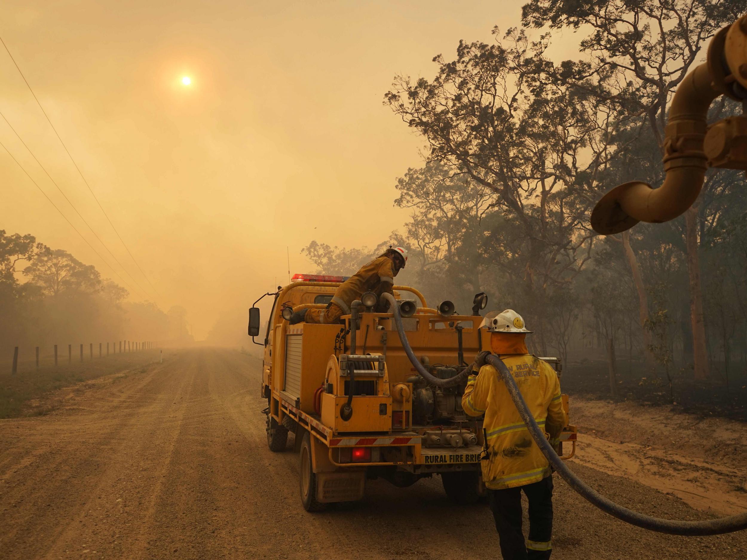 Firefighters refill their water from a tanker in Deepwater National Park on Wednesday