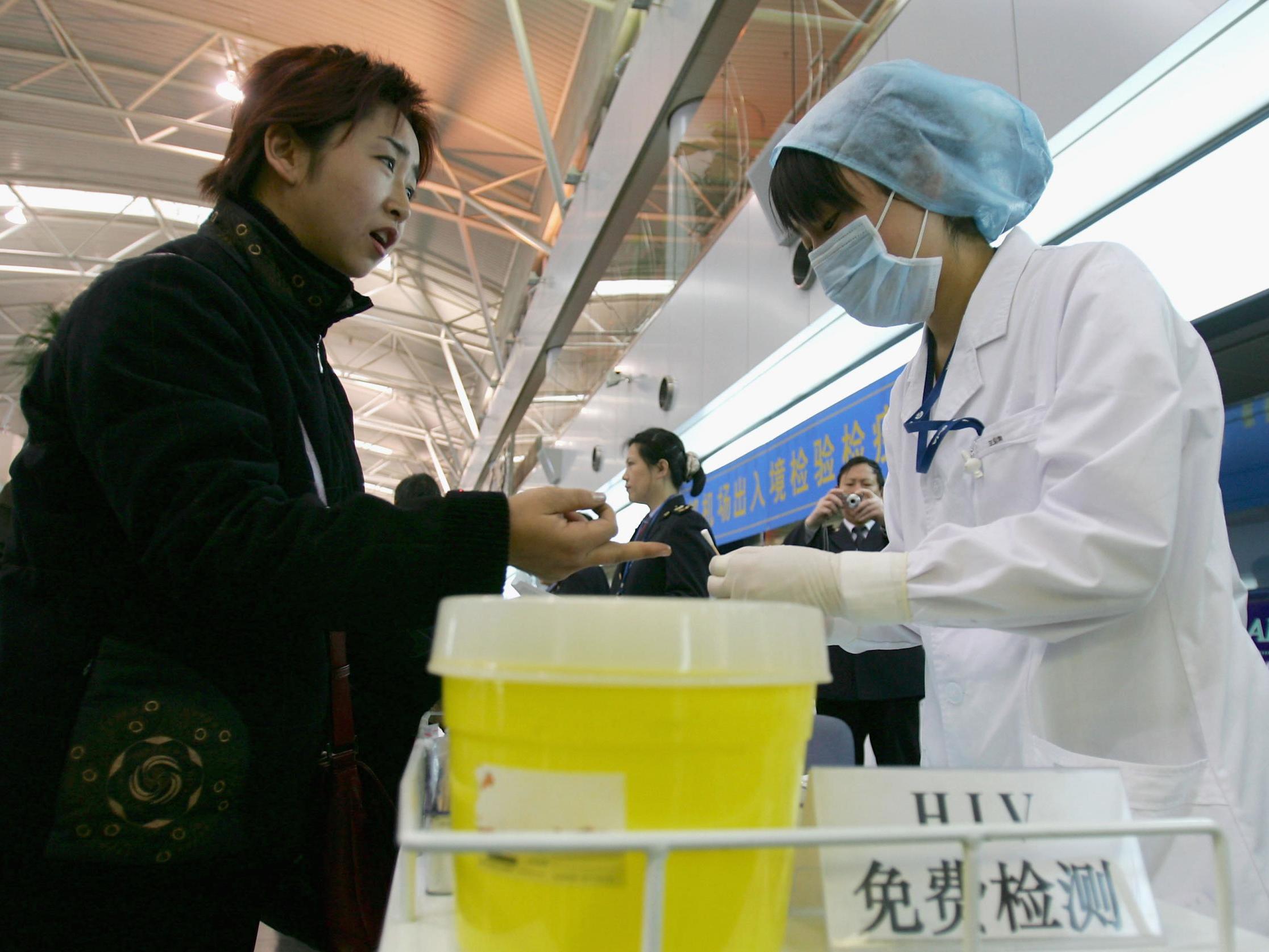 A Chinese passenger receives a free HIV check at Beijing International Airport