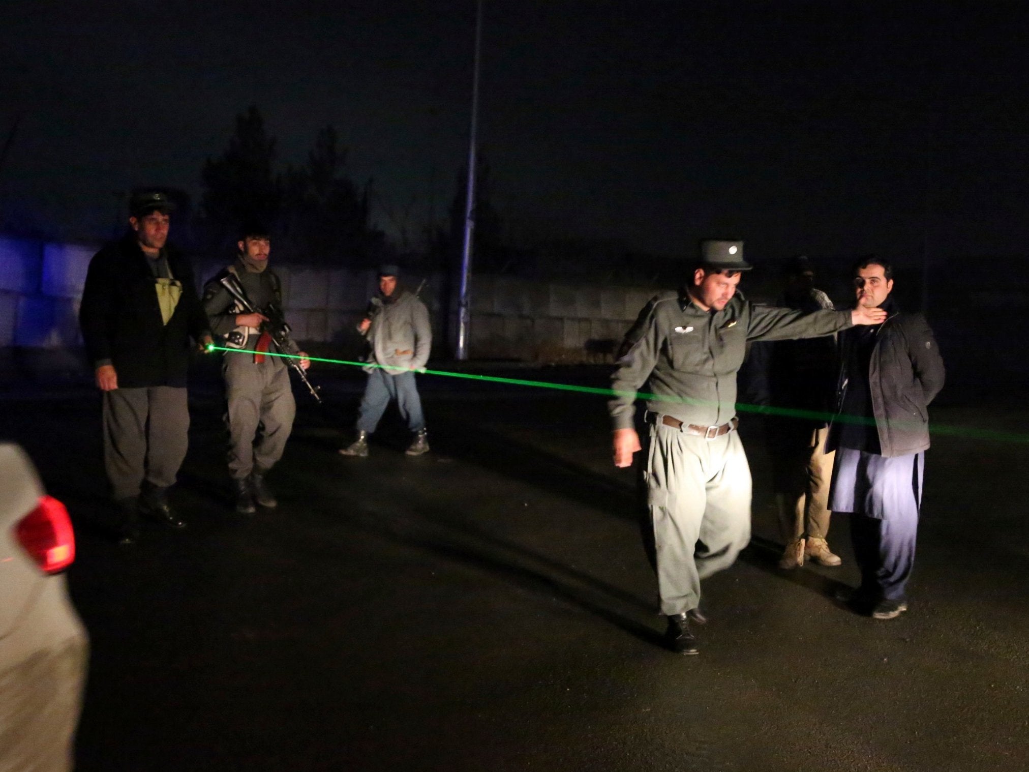 Security forces block the roads at the site of a suicide bomb which was followed by an insurgent attack on forces in the area