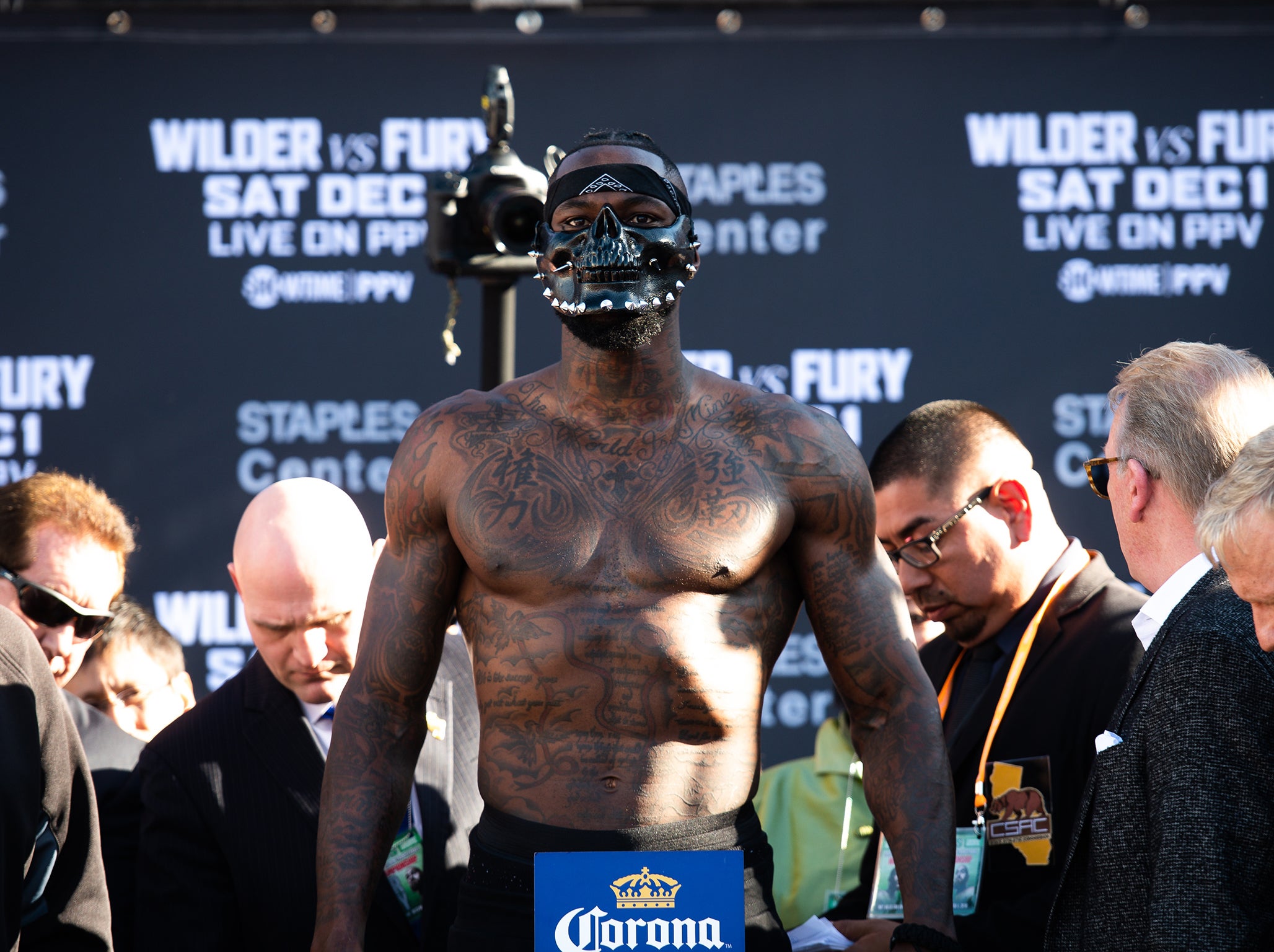 A masked Deontay Wilder on the scales