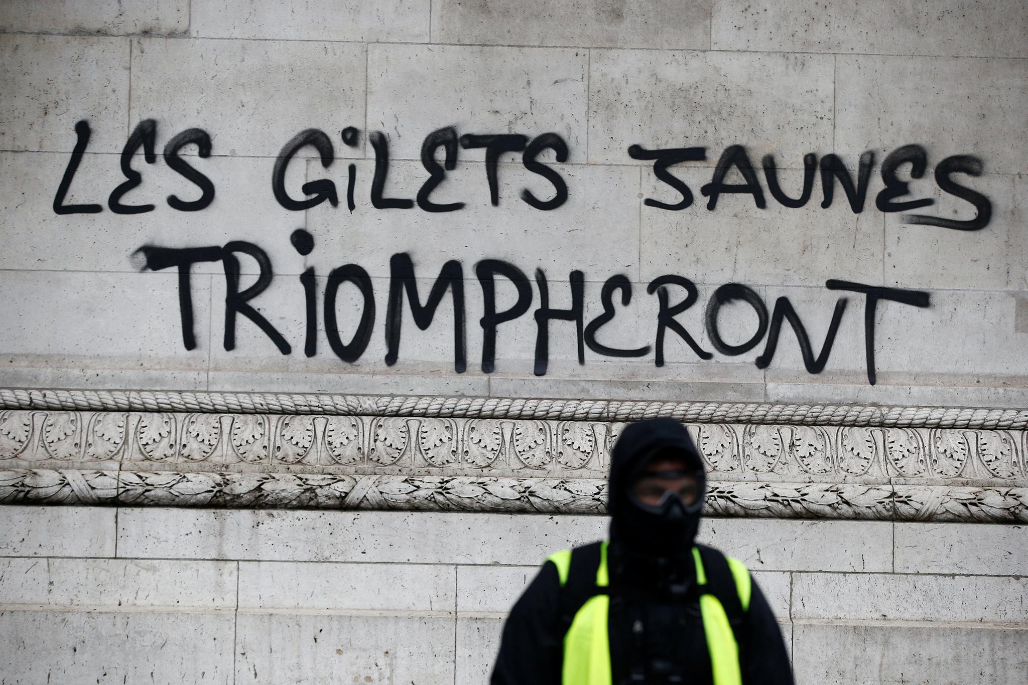 The yellow vests will triumph is scrawled across the Arc de Triomphe