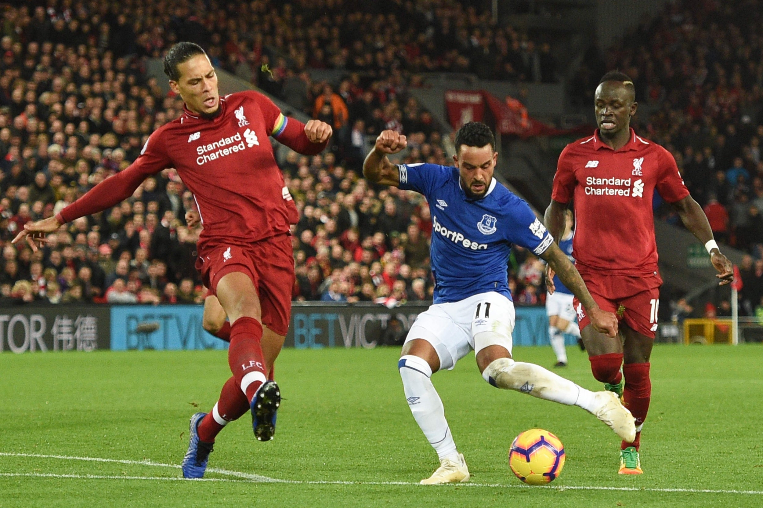 Virgil van Dijk leaps to block a shot from Theo Walcott