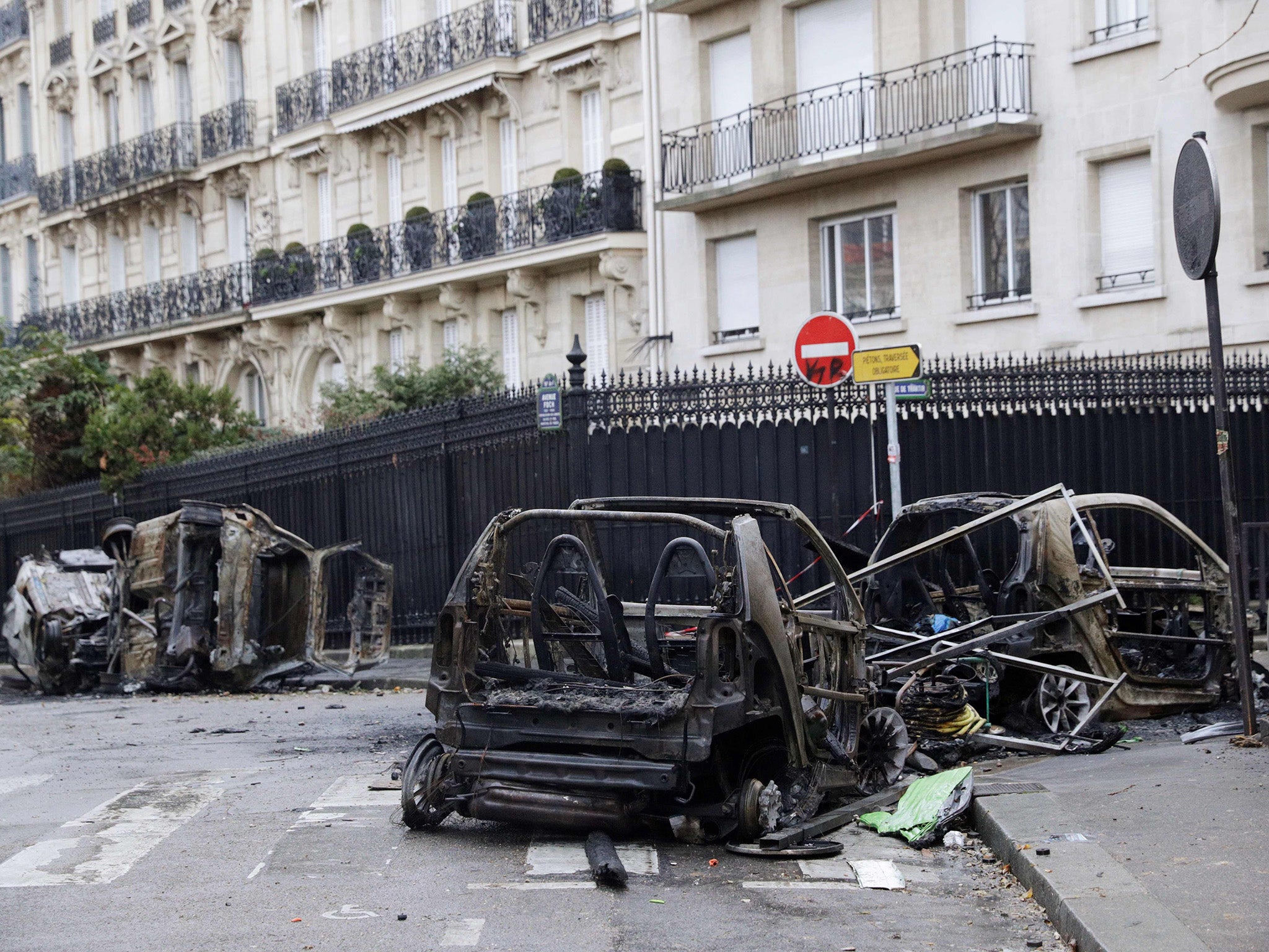 Burned cars are left behind after the clashes in Paris