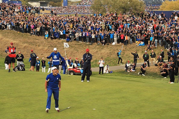 Rahm celebrates after defeating Woods in the singles in Paris