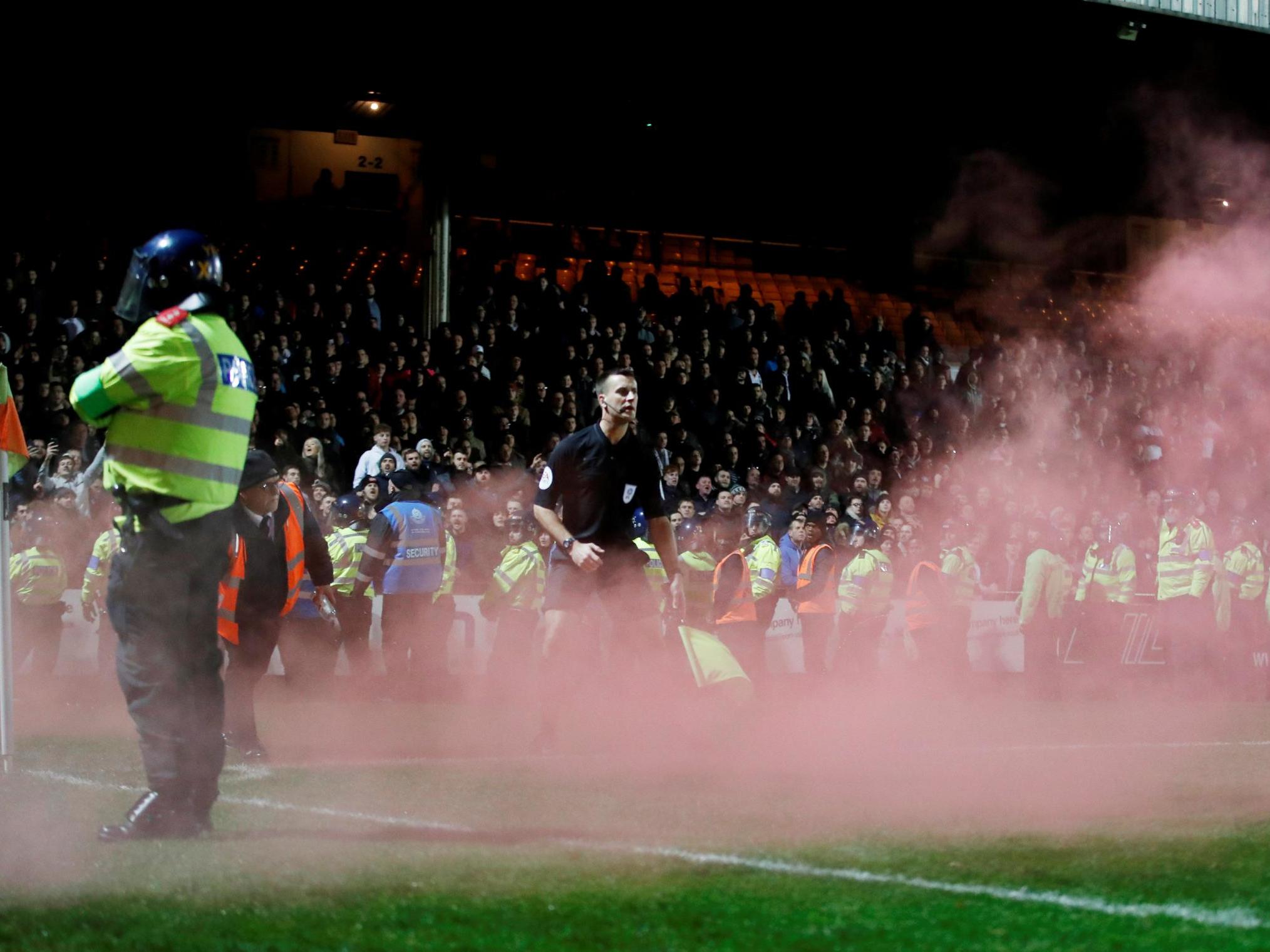 Fans threw flares onto the pitch