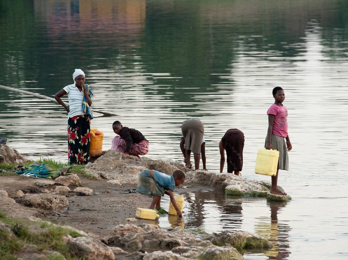 Women collect water from the lake. Gender roles have been redefined in Rwanda since the genocide