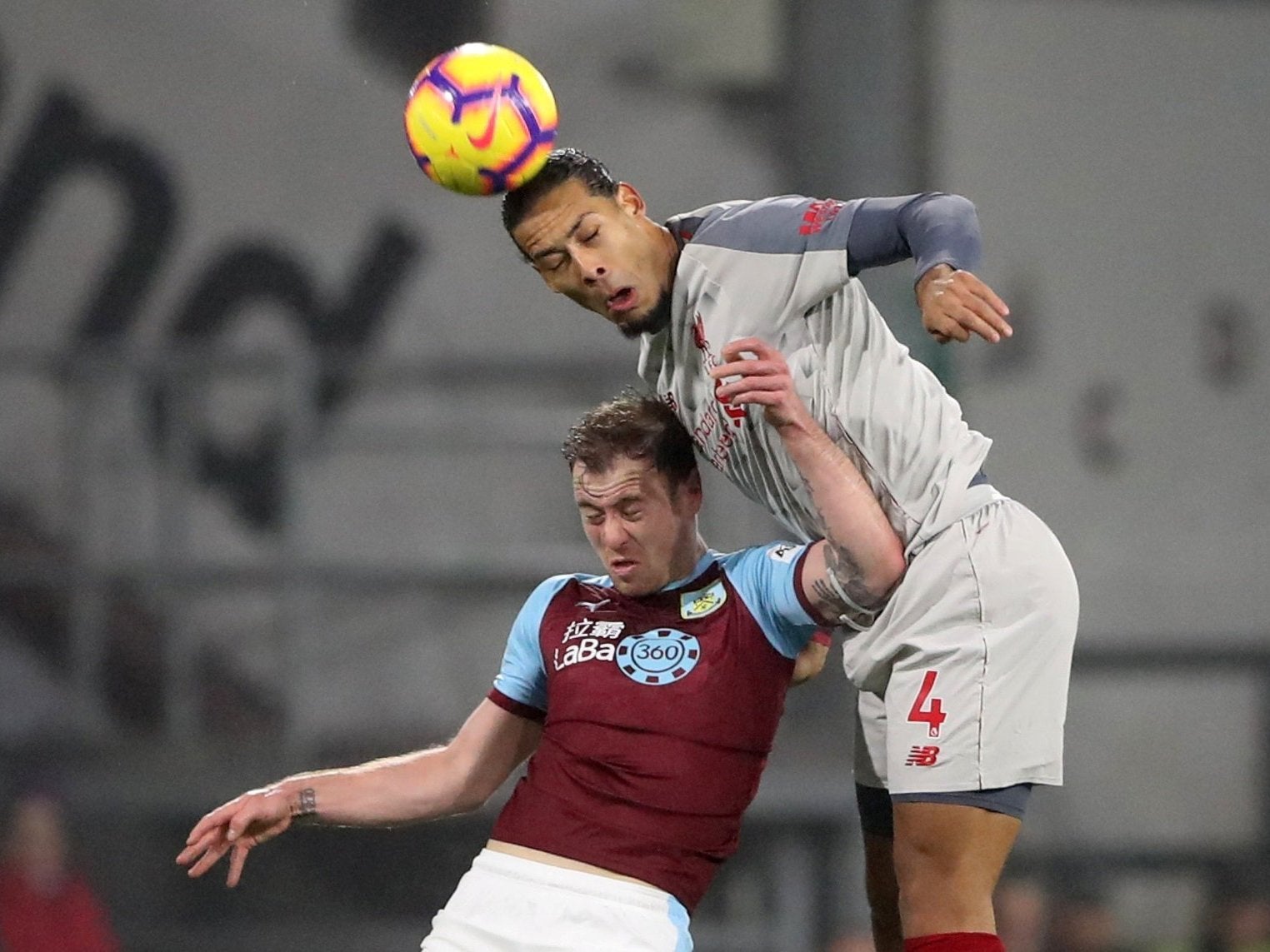 Virgil van Dijk challenges Ashley Barnes in the air