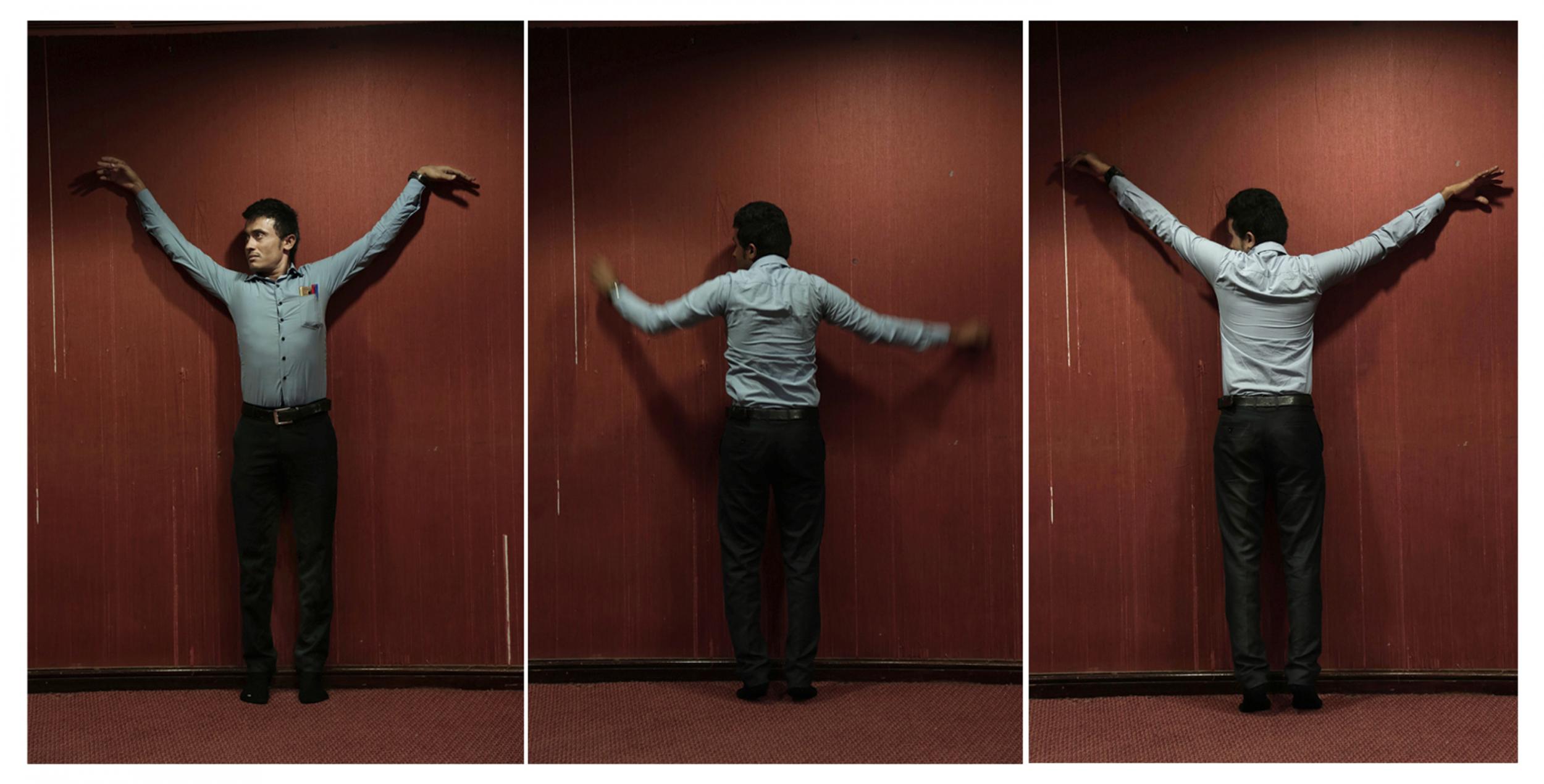 Yemeni medic Farouk Baakar demonstrates how he was shackled to a wall during his torture in a prison run by Yemen’s Houthi rebels (AP/Nariman El-Mofty)