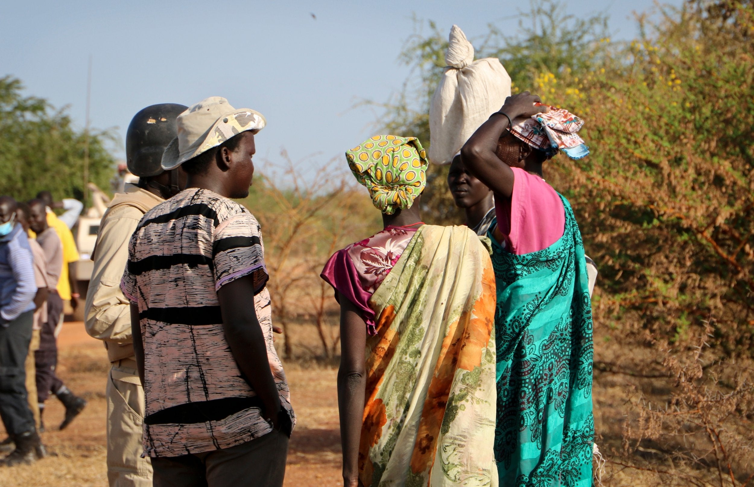 Women and girls speak to members of a UN peacekeeping patrol as they walk to get food in Bentiu