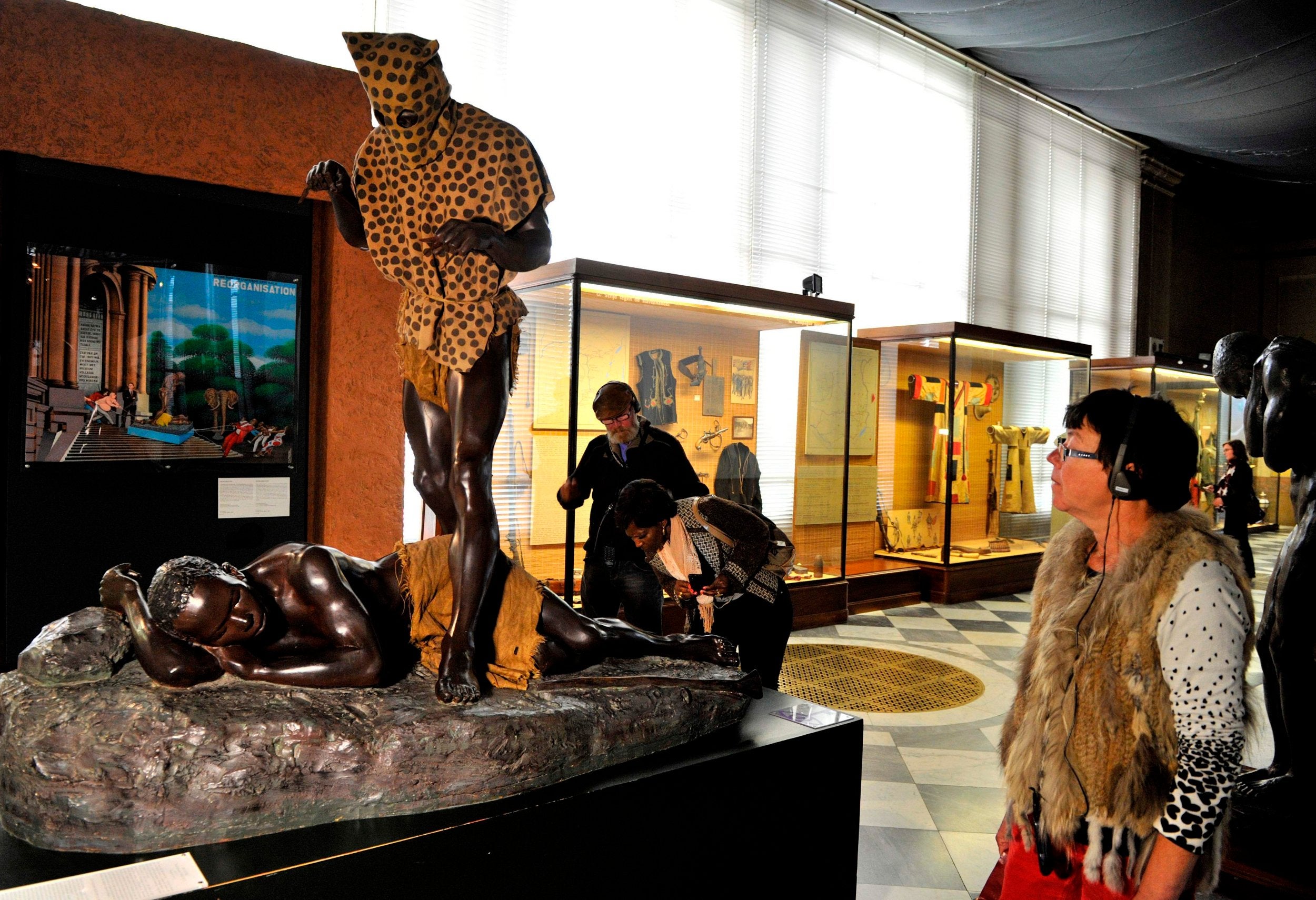 A woman looks at the sculpture of the "leopard man" at the Museum of Central Africa (RMCA) in Tervuren