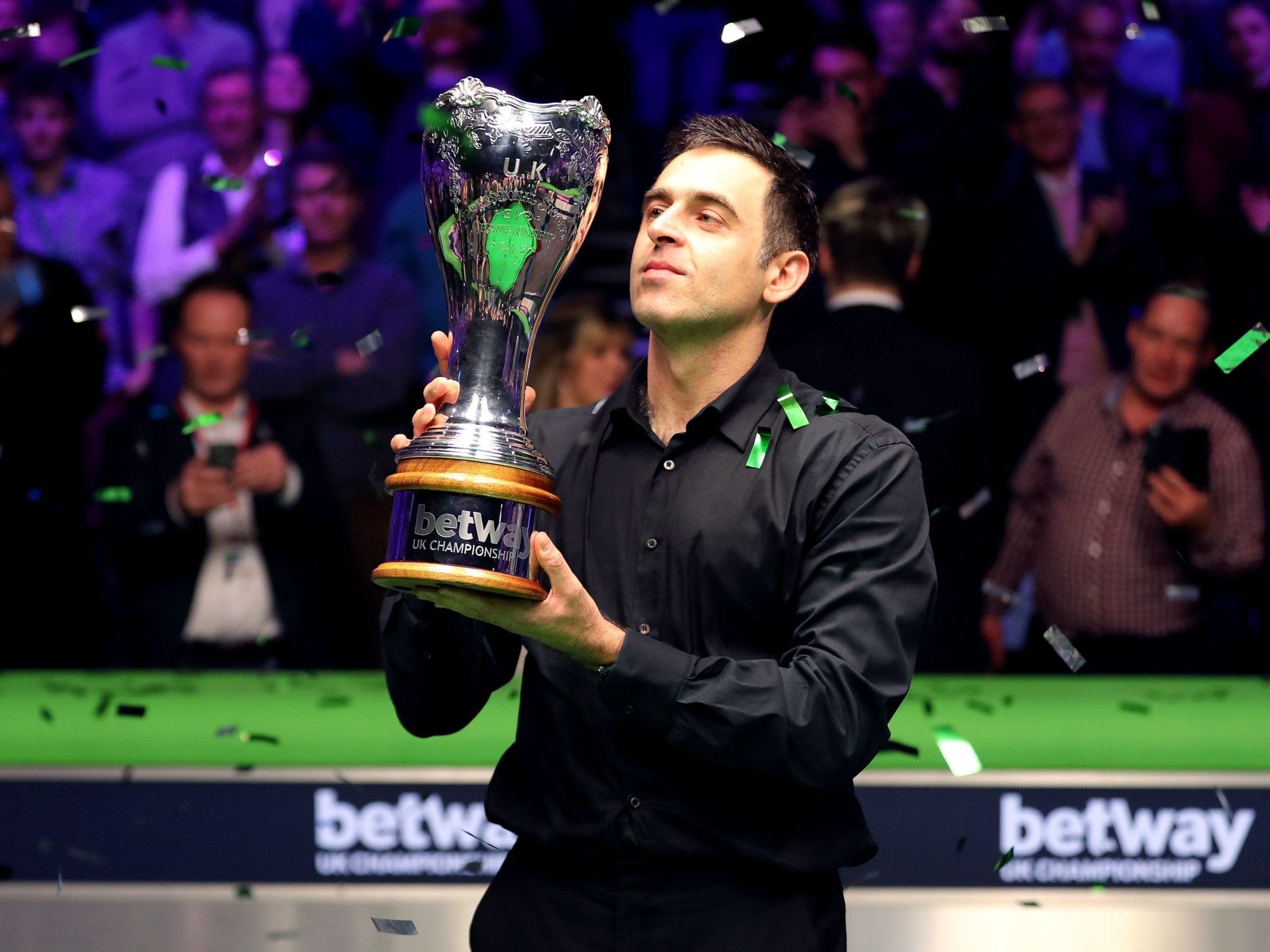 Ronnie O’Sullivan collects the UK Championship trophy