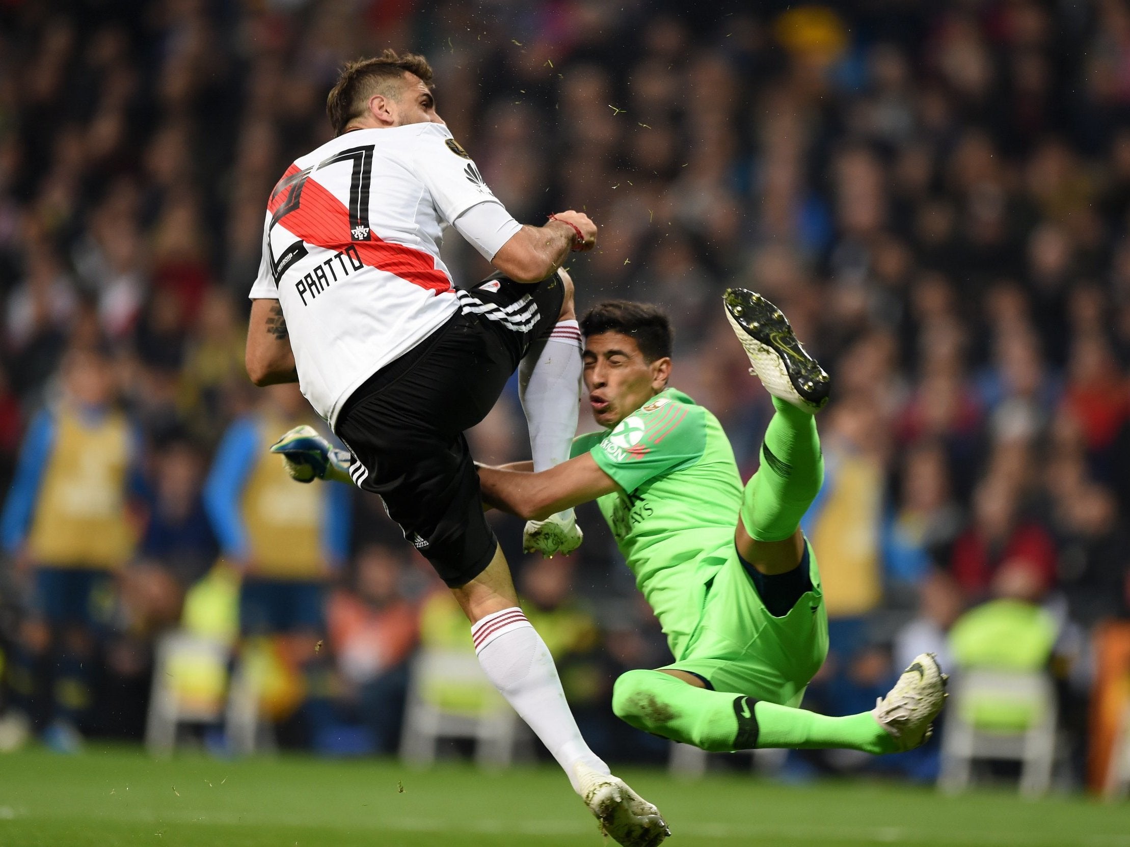 River Plater's Lucas Pratto collides with Boca Juniors goalkeeper Esteban Andrada