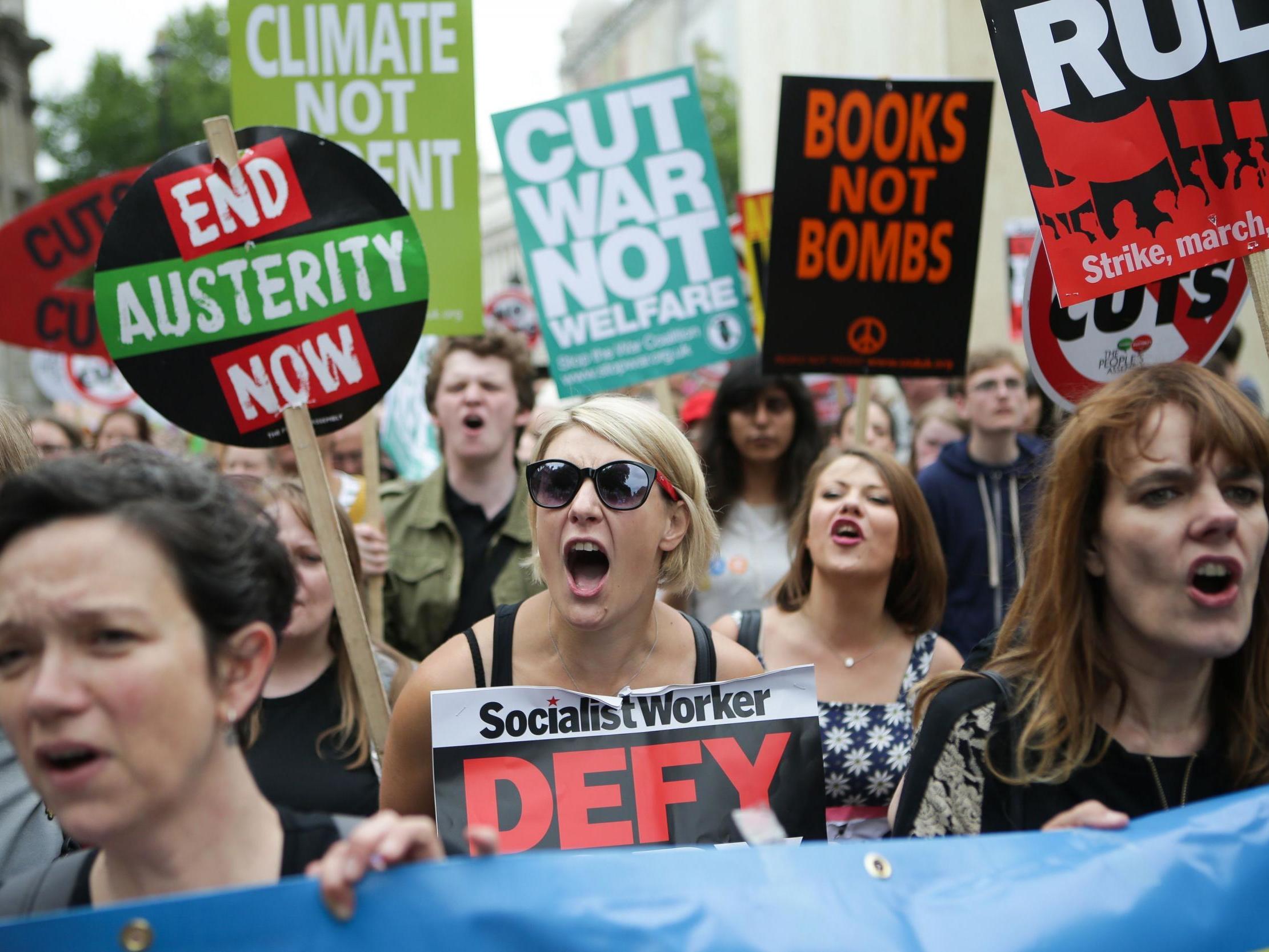 Anti-austerity protesters march in front of Downing Street