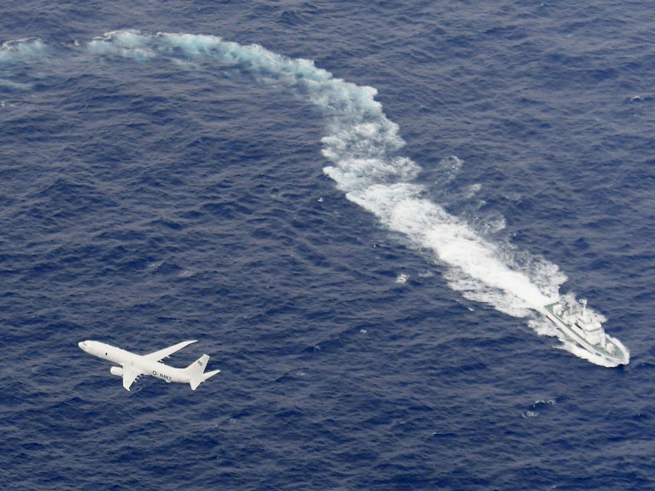 A Japan Coast Guard patrol vessel and US Navy aeroplane conduct search and rescue operation at the area where two US Marine Corps aircraft have been involved in a mishap in the skies, off the coast of Kochi prefecture, Japan