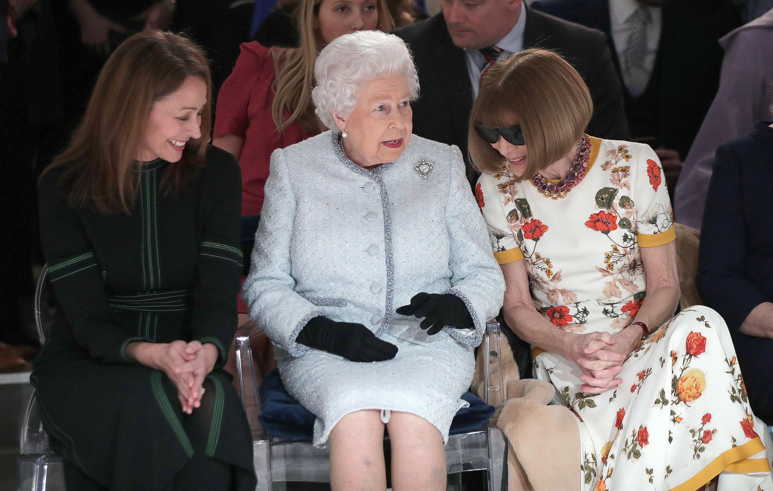 Queen Elizabeth II, accompanied by chief executive of the British Fashion Council (BFC), Caroline Rush and American Vogue editor Anna Wintour, pictured at Richard Quinn's AW18 runway show before she presented him with the inaugural Queen Elizabeth II Award for British Design on 20 Februrary 2018.