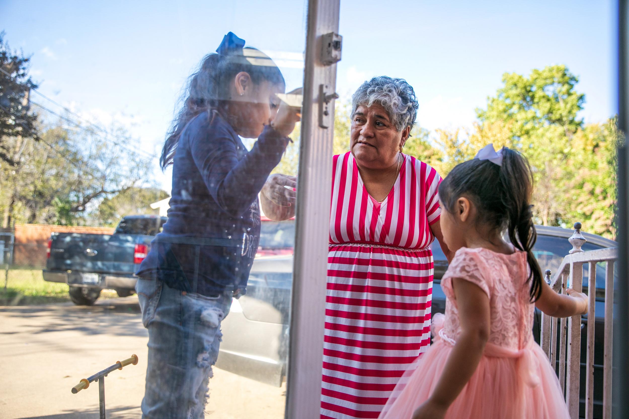 Maria Cisneros is raising grandchildren Haidy, left, and Alyson