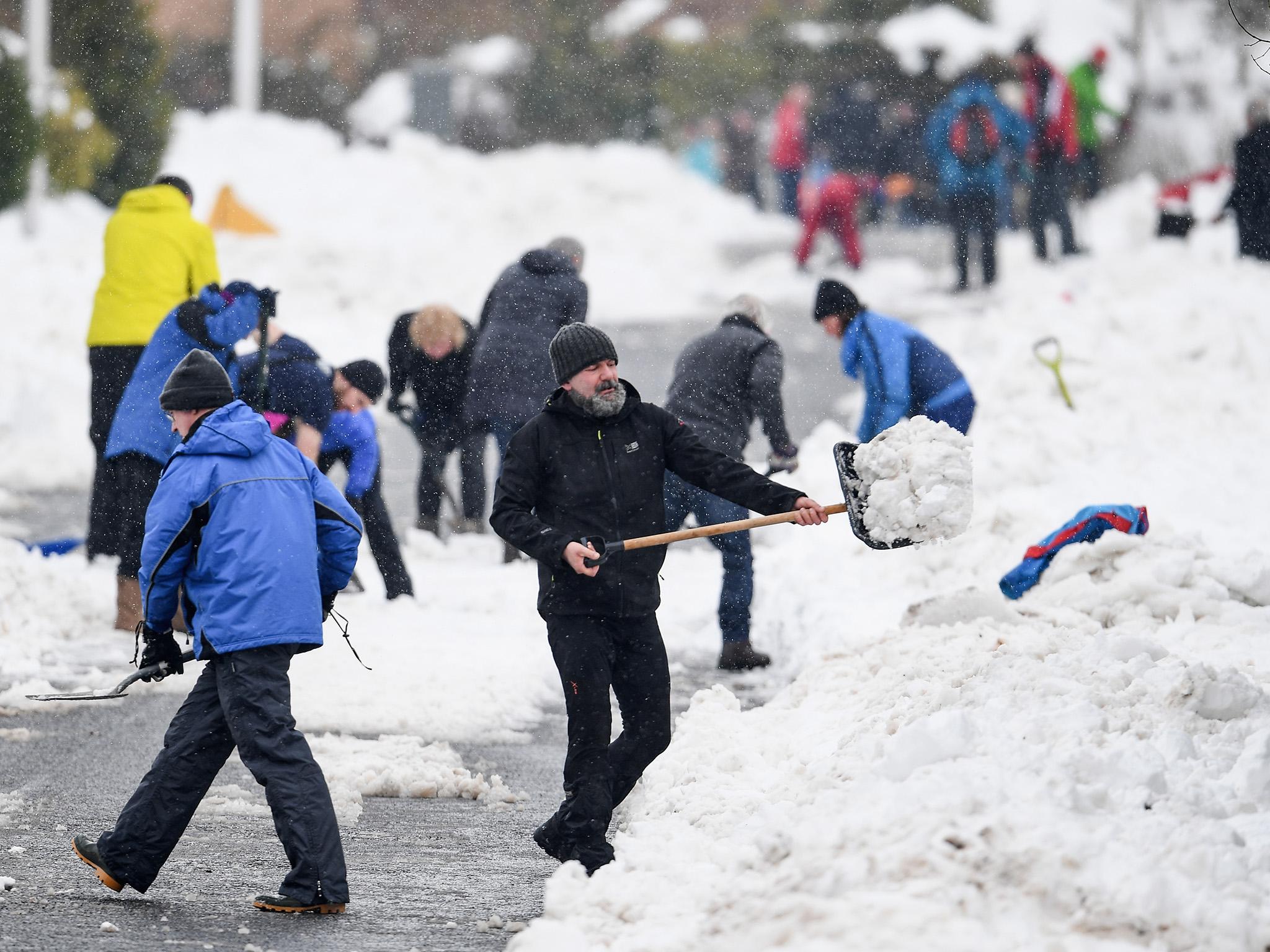 Snow patrol: neighbours working together to clear the snow indicates – at one level – that society still exists