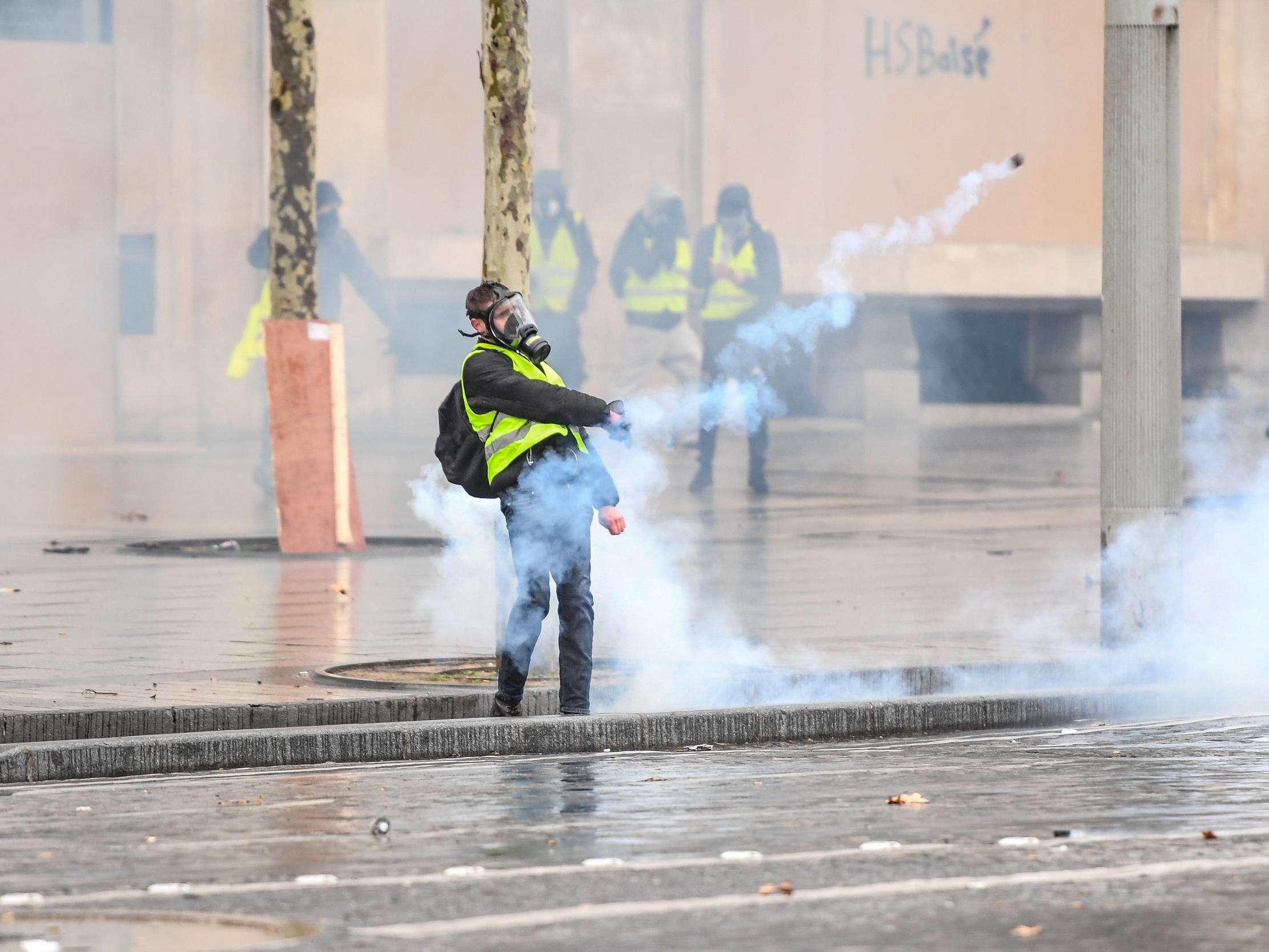 A protester stands on the Champs Elysees