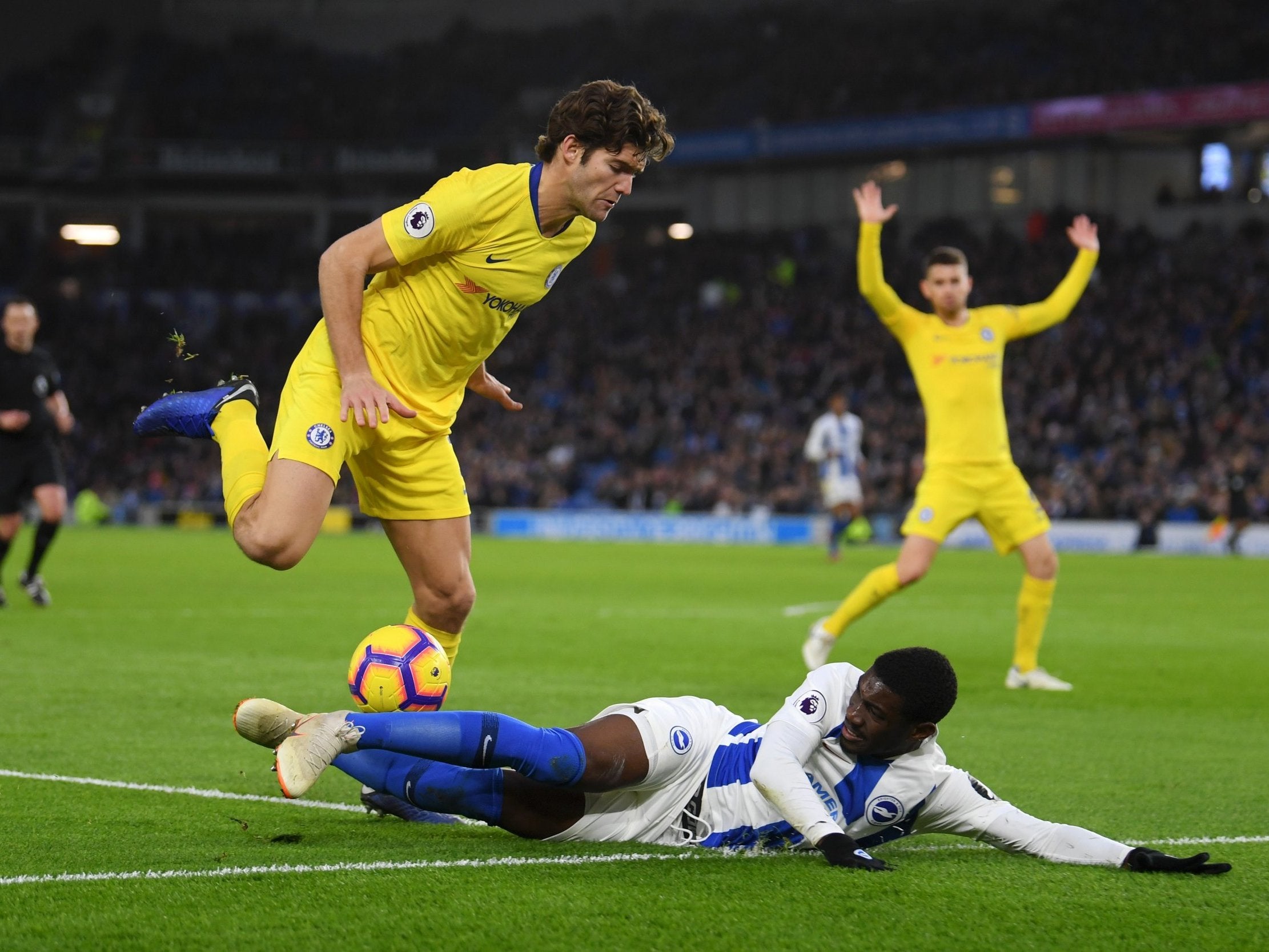 Marcos Alonso is challenged by Yves Bissouma