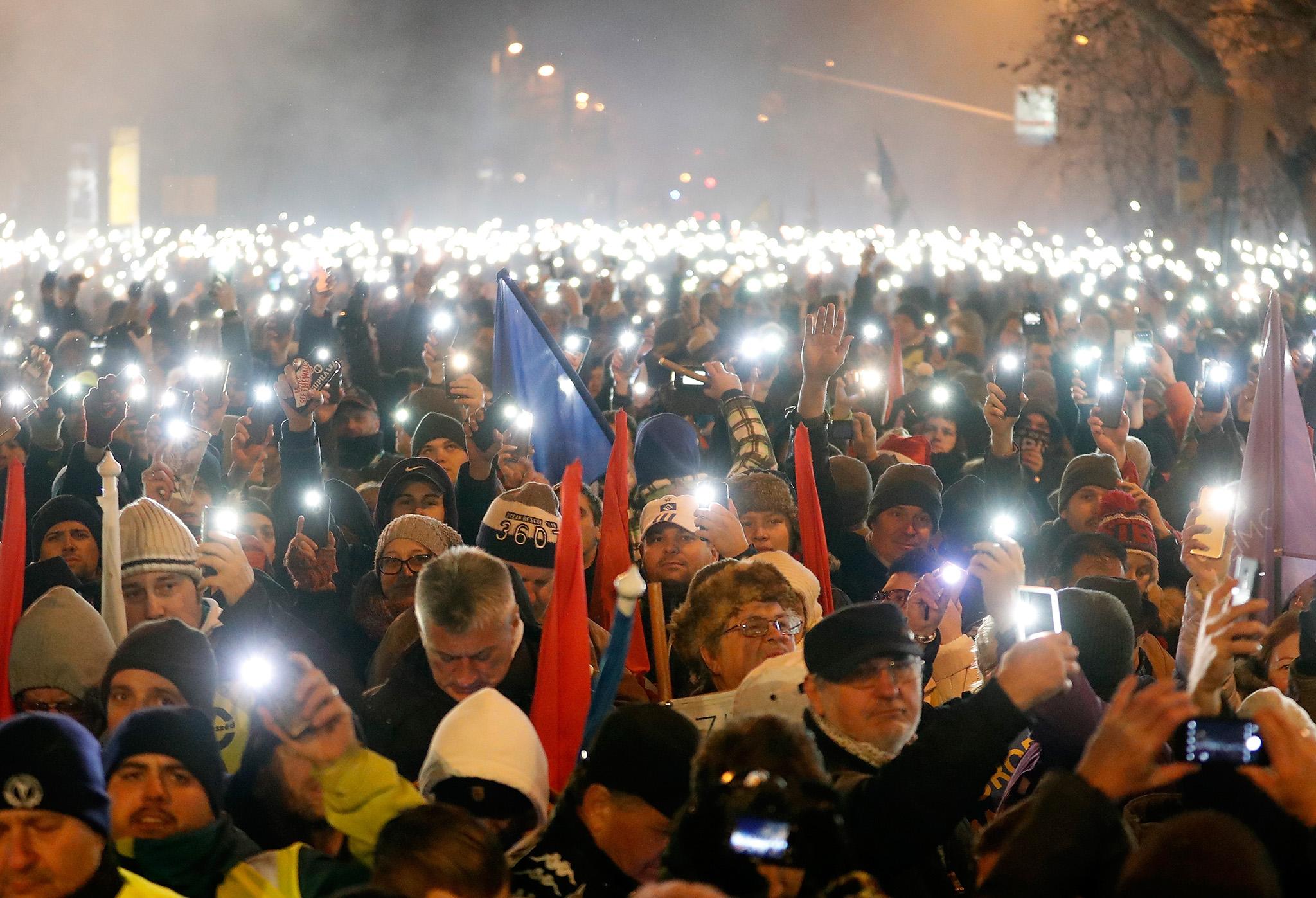 Anti-government demonstrators gathered outside parliament in Budapest on 16 December