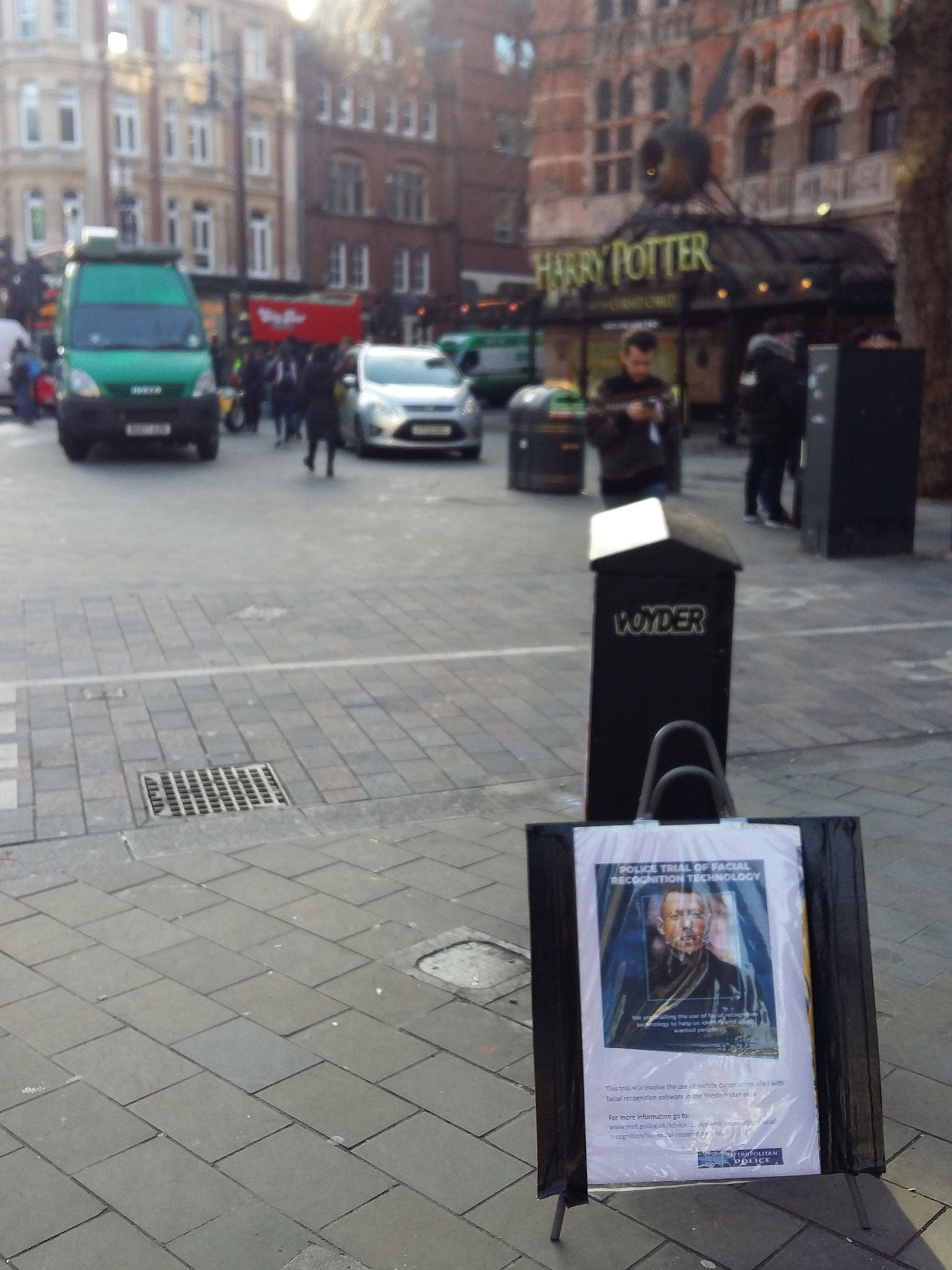 A sign saying facial recognition technology is in use ahead of an unmarked police van mounted with cameras in London’s West End on 17 December 2018