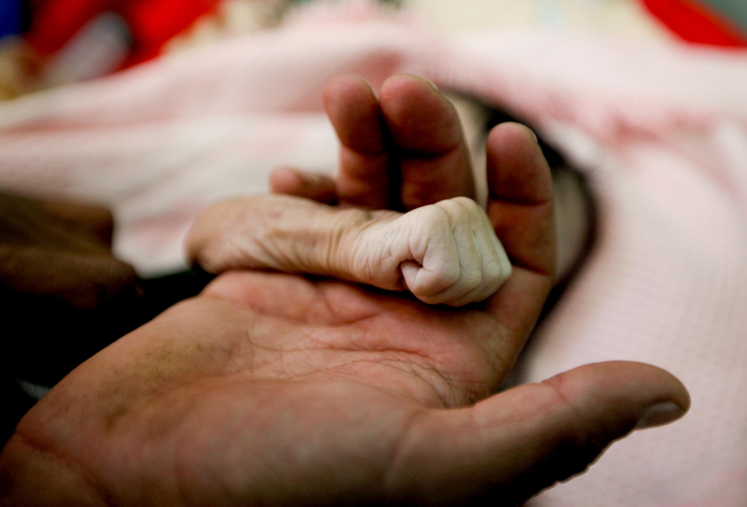 A Yemeni father mourns a baby girl who died of starvation